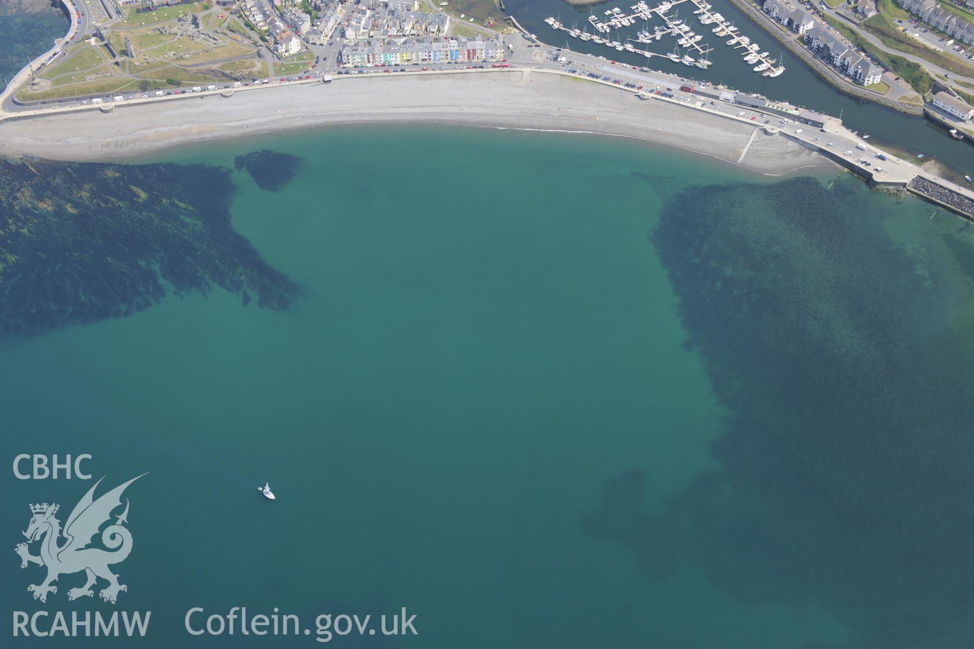 The town of Aberystwyth, including views of the castle, harbour and south beach. Oblique aerial photograph taken during the Royal Commission?s programme of archaeological aerial reconnaissance by Toby Driver on 12 July 2013.