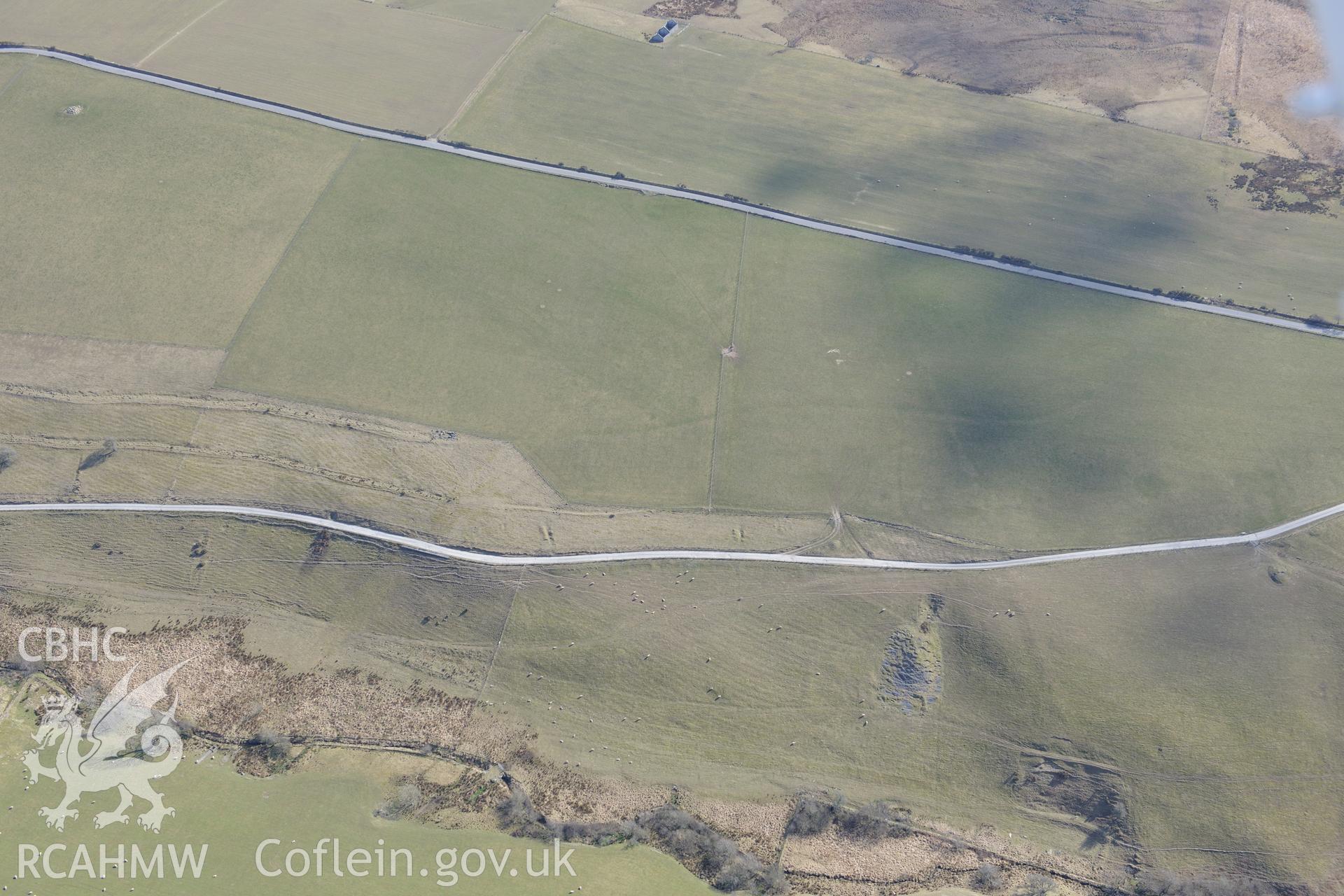 Earthworks south of Mynydd Gorddu lead mine, with Banc Troed Rhiw Seiri ring barrow in the top left of the photograph. Oblique aerial photograph taken during Royal Commission?s programme of archaeological aerial reconnaissance by Toby Driver on 2/4/2013.