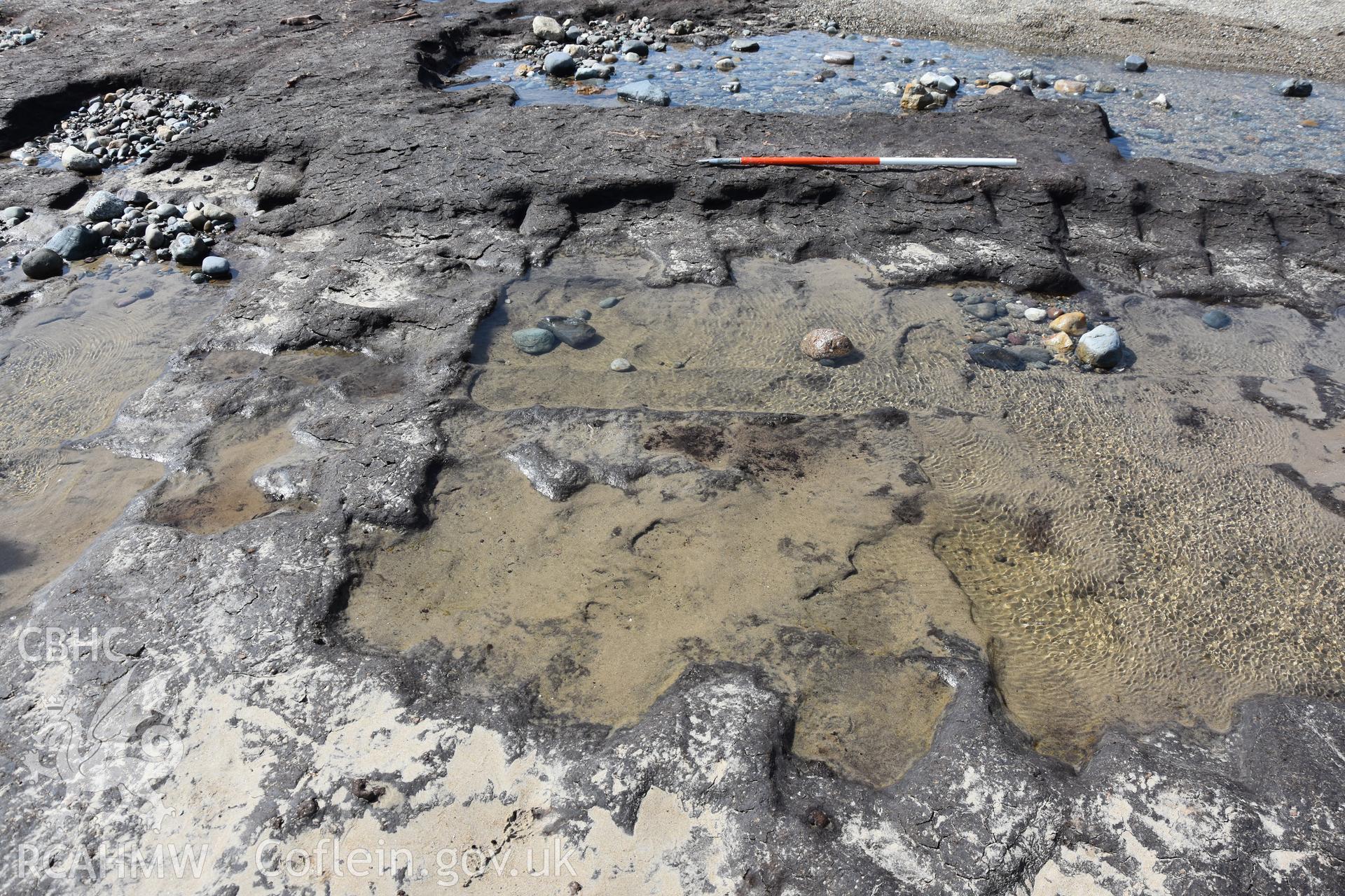 Photography of medieval or post-medieval peat cuttings preserved in the eastern part of the peats on The Warren beach, Abersoch. Recorded with GNSS and photogrammetry for the CHERISH Project. ? Crown: CHERISH PROJECT 2018. Produced with EU funds through the Ireland Wales Co-operation Programme 2014-2020. All material made freely available through the Open Government Licence.