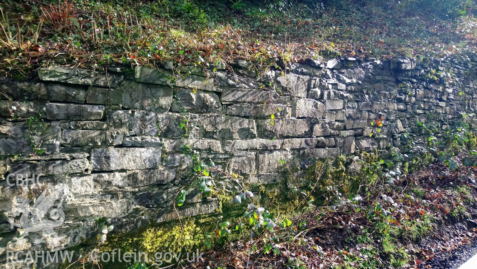 Photographs taken on 15th March 2018 of historic retaining wall at Castle Hill, Llanilar, built of local sandstone blocks closely replicating the appearance of the original Roman walls of the Abermagwr Roman villa which were built of the same stone.