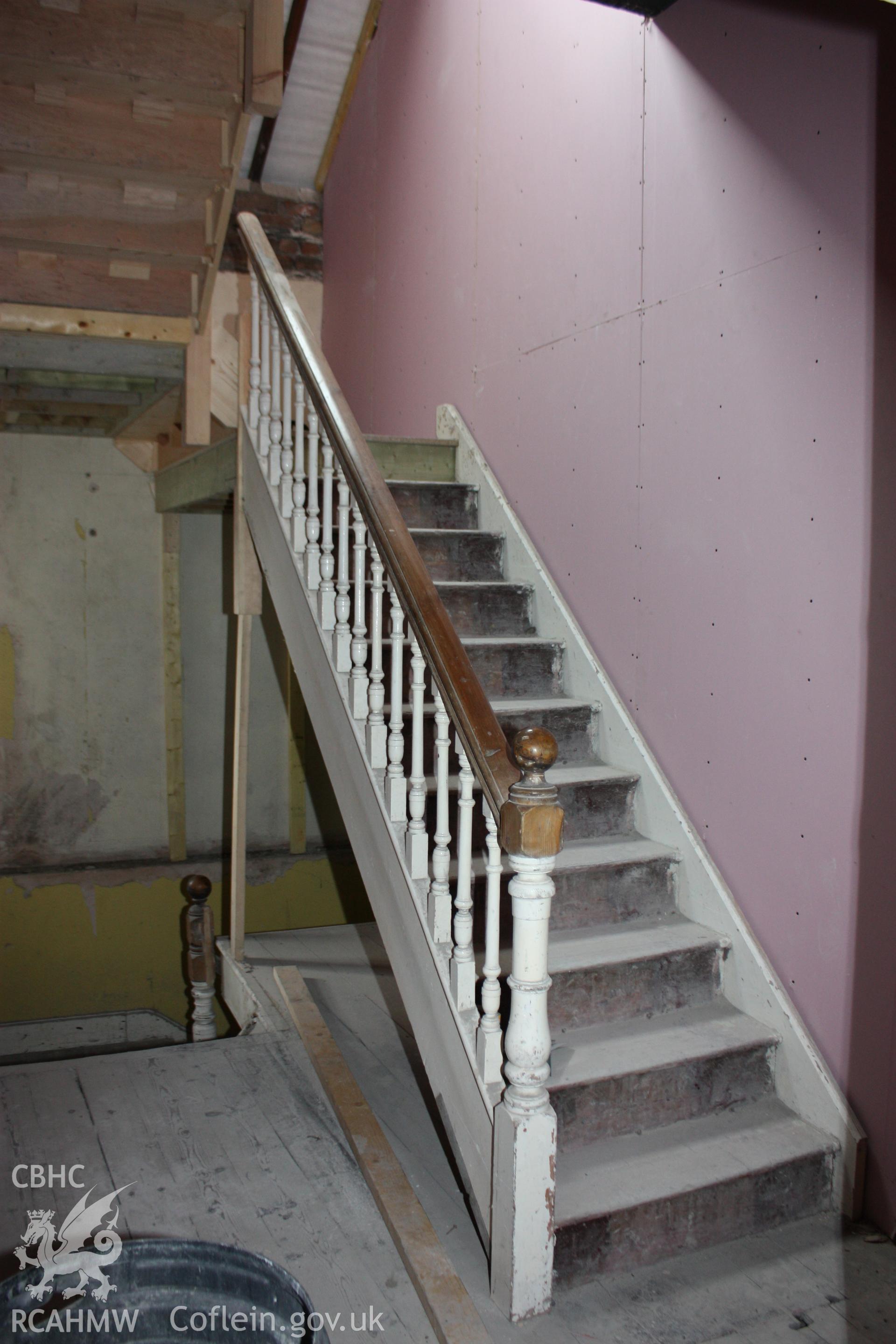 Colour photograph showing interior view of stair from second floor to the attic level at the Old Auction Rooms/ Liberal Club in Aberystwyth. Photographic survey conducted by Geoff Ward on 9th June 2010 during repair work prior to conversion into flats.