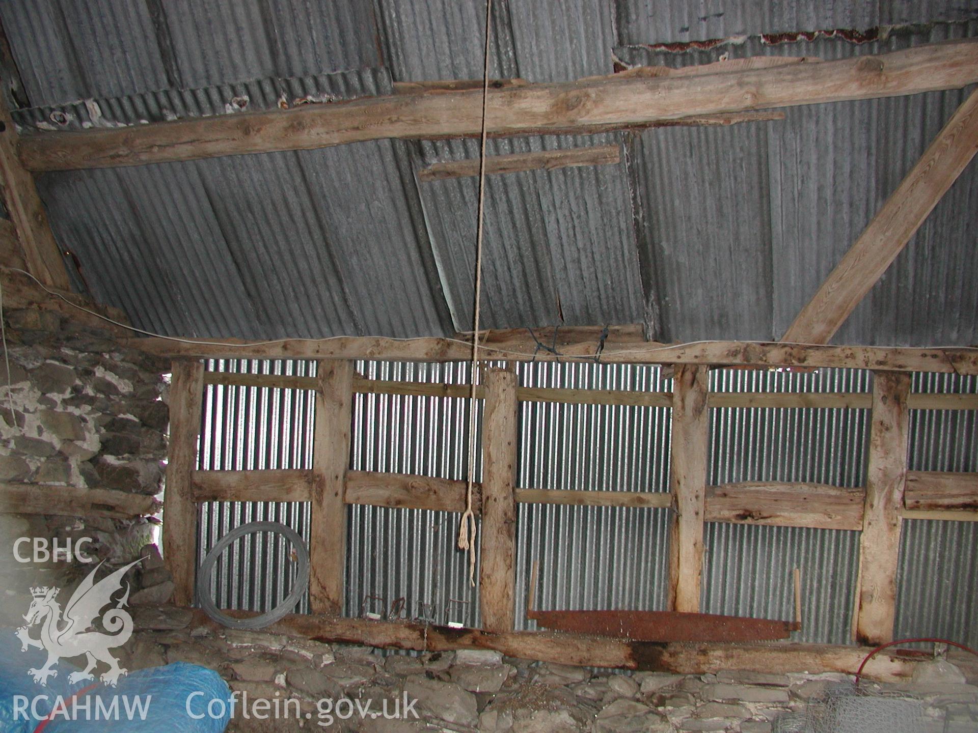 Interior view of barn or shed at Pistyll Gwyn showing timber frame, stone wall and corrugated iron roof. Photographic survey of Pistyll Gwyn Farmstead conducted by Geoff Ward on 13th November 2007.