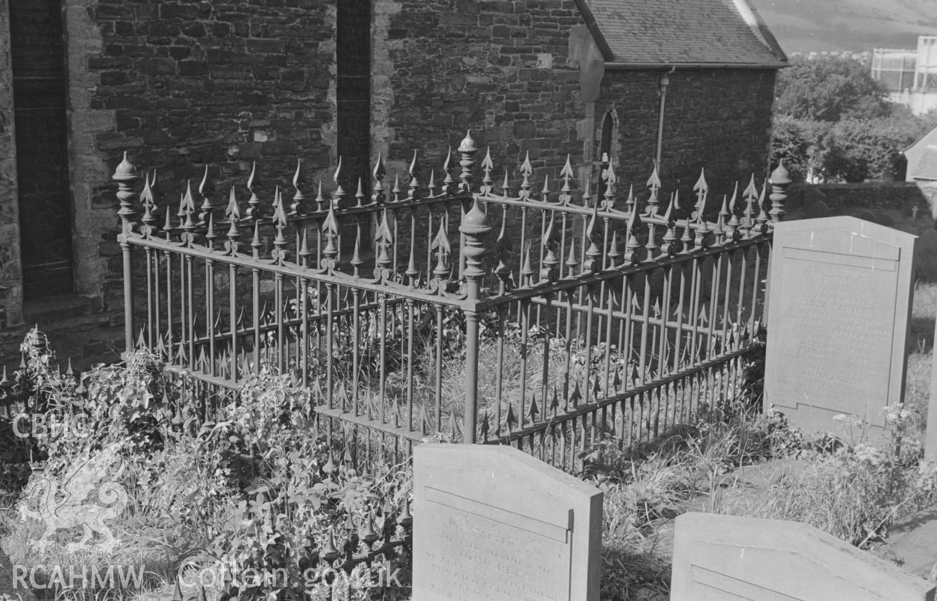 Digital copy of black & white negative showing cast iron enclosure in graveyard just north east of north transept of St. Padarn's church, Llanbadarn. Photographed by Arthur O. Chater on 19th August 1967, looking south west from Grid Reference SN 599 810.