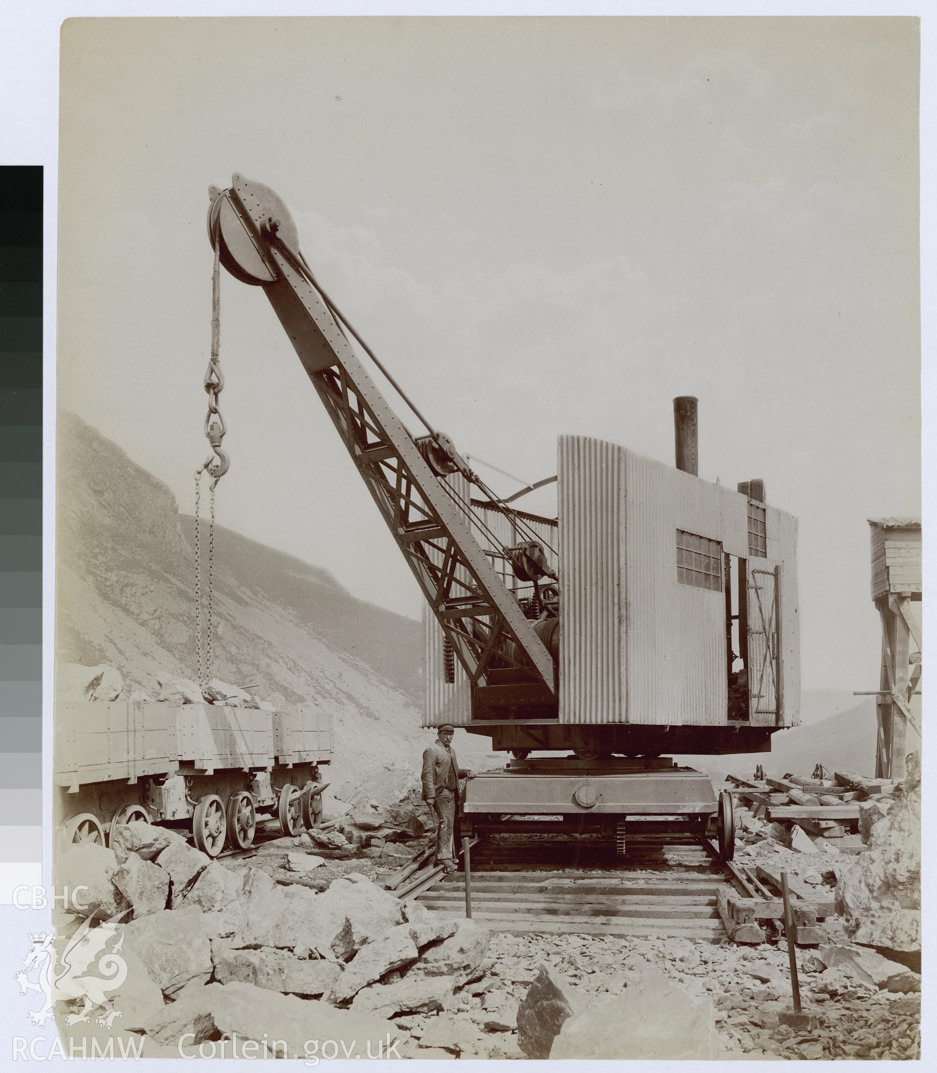 Digital copy of an albumen print from Edward Hubbard Collection showing crane loading trucks with rocks.
