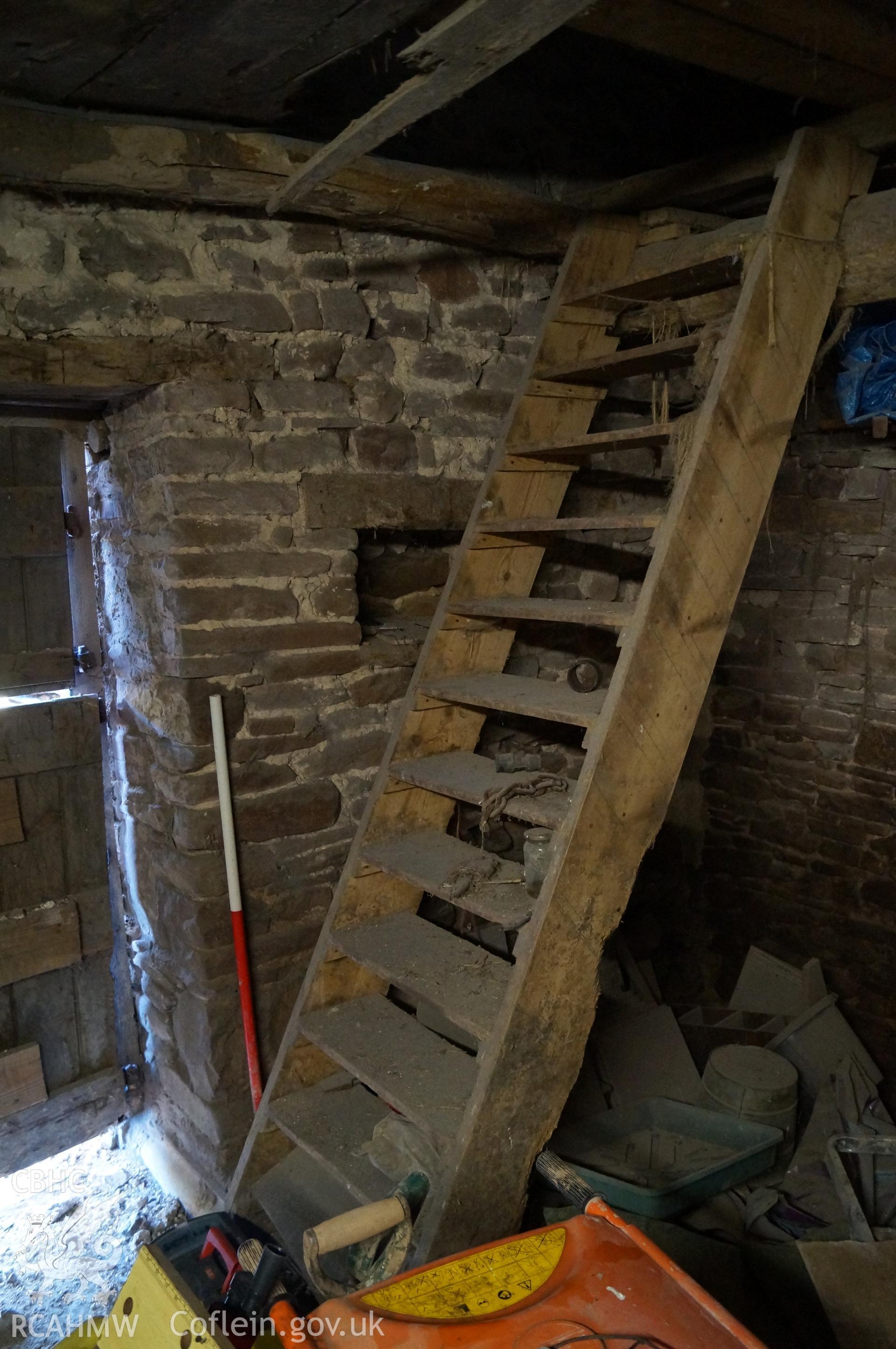 Interior view 'looking south southeast at the stables southeast corner, showing steps to loft and small niche behind, with doorway on left of photograph' on Gwrlodau Farm. Photograph and description by Jenny Hall and Paul Sambrook of Trysor, 9th Feb 2018.