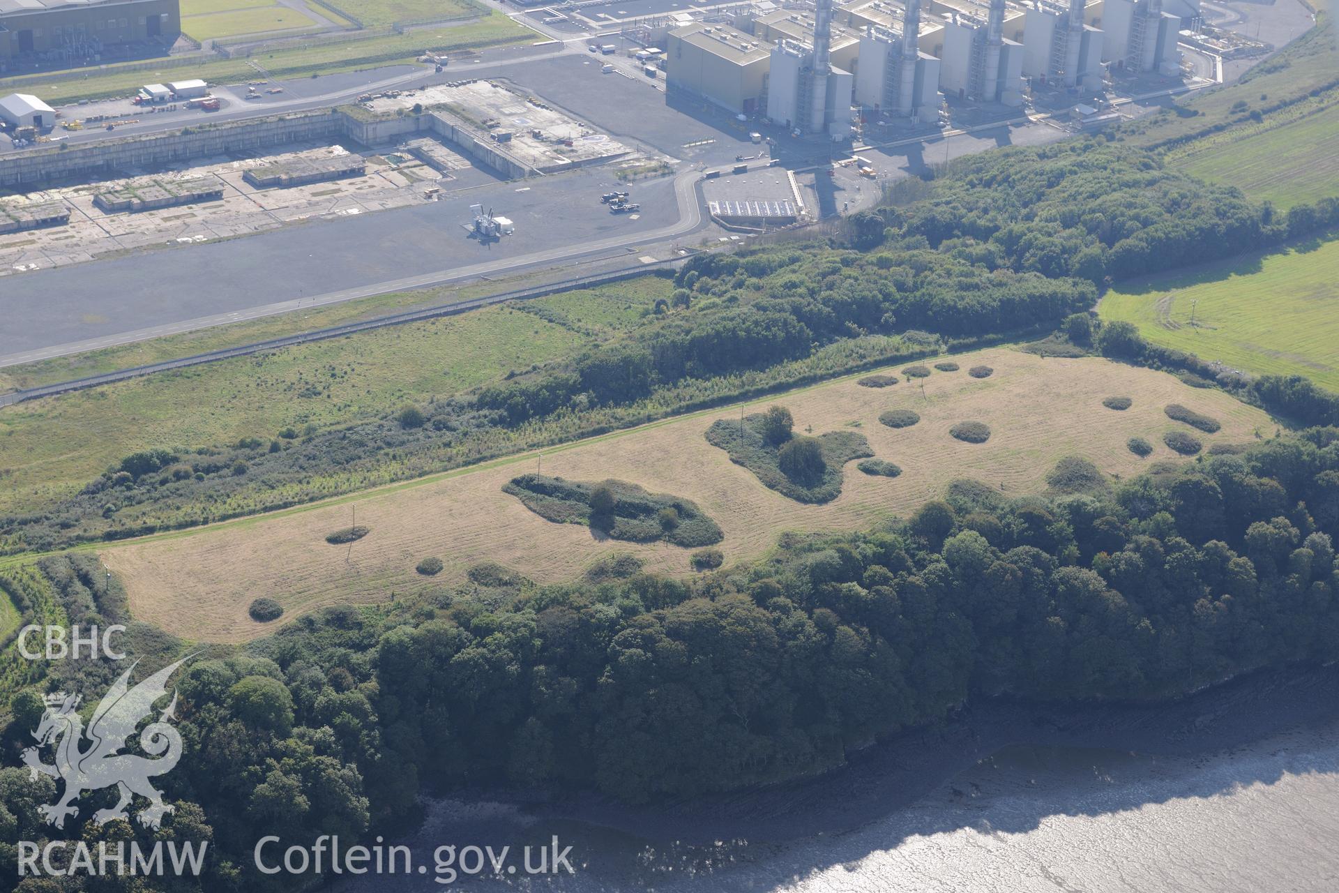 West Pennar Rath defended enclosure, with Pembroke power station behind. Oblique aerial photograph taken during the Royal Commission's programme of archaeological aerial reconnaissance by Toby Driver on 30th September 2015.
