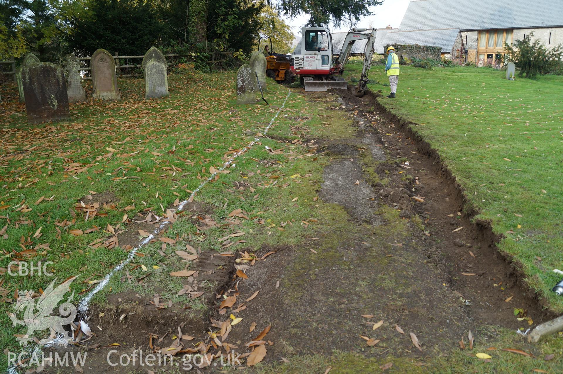 View 'looking west northwest at the trench on northeastern side of path, no archaeologically significant contexts records or artefacts retrieved' at St. Mary's church, Gladestry. Photograph & description by Jenny Hall & Paul Sambrook of Trysor, 16/10/2017.