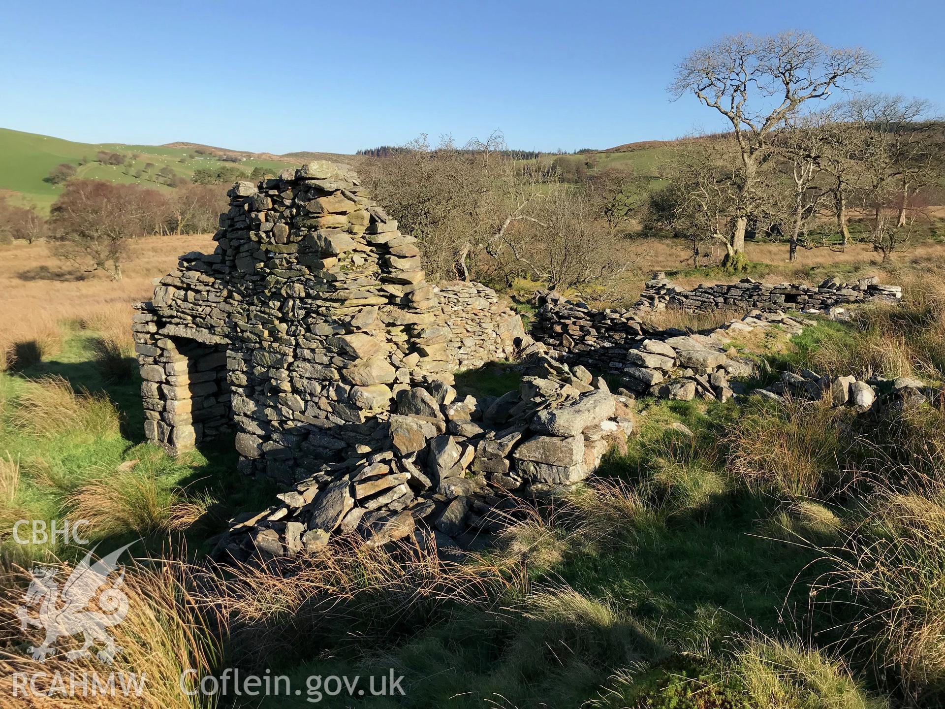 Detailed view of the remains of a doorway and stone walls belonging to a cottage west of the ruined Caradog house, which is south west of Bryneithinog farm, Ystrad Fflur. Colour photograph taken by Paul R. Davis on 18th November 2018.