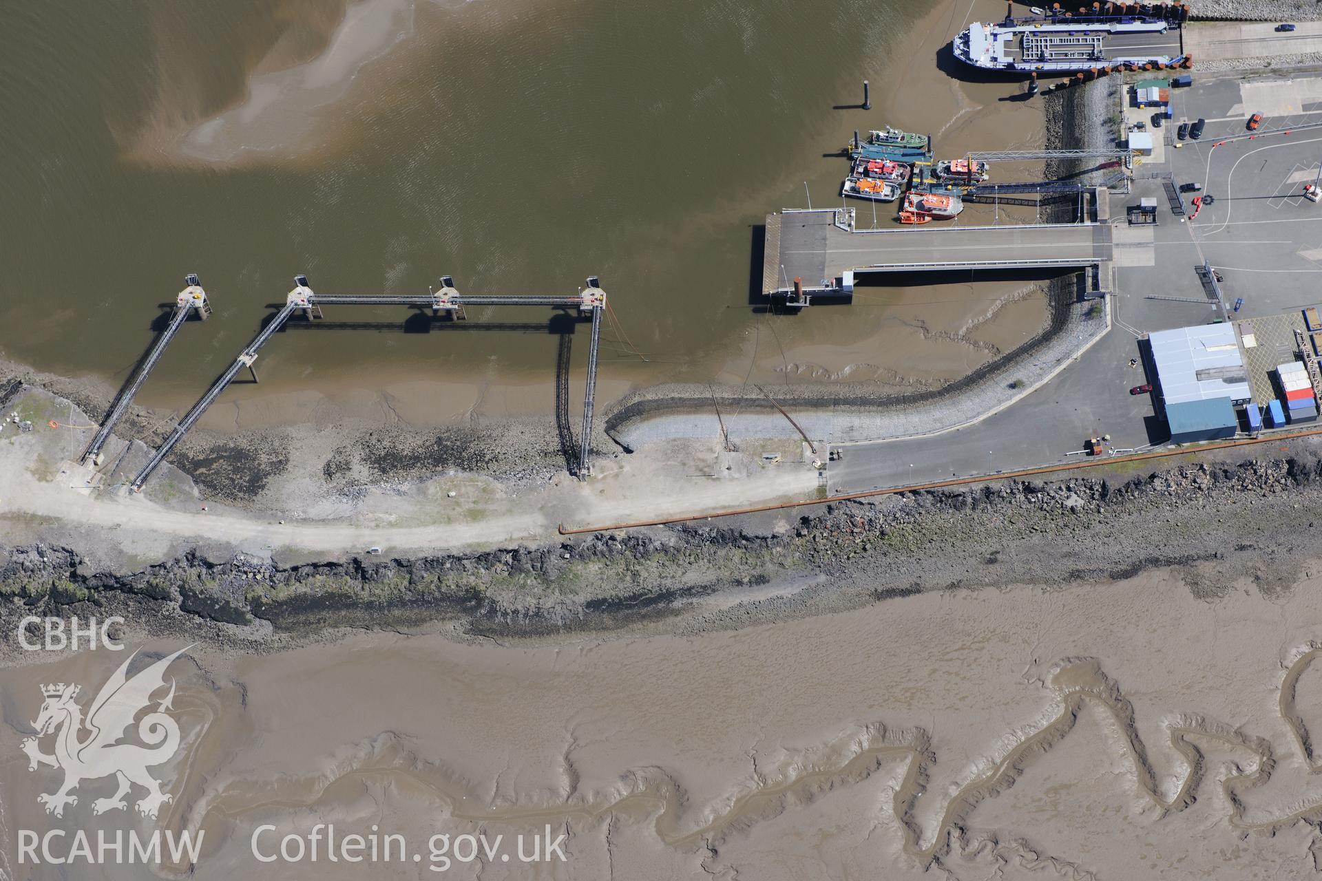 Mostyn Quay in the port of Mostyn, with windfarm parts. Oblique aerial photograph taken during the Royal Commission?s programme of archaeological aerial reconnaissance by Toby Driver on 22nd May 2013.