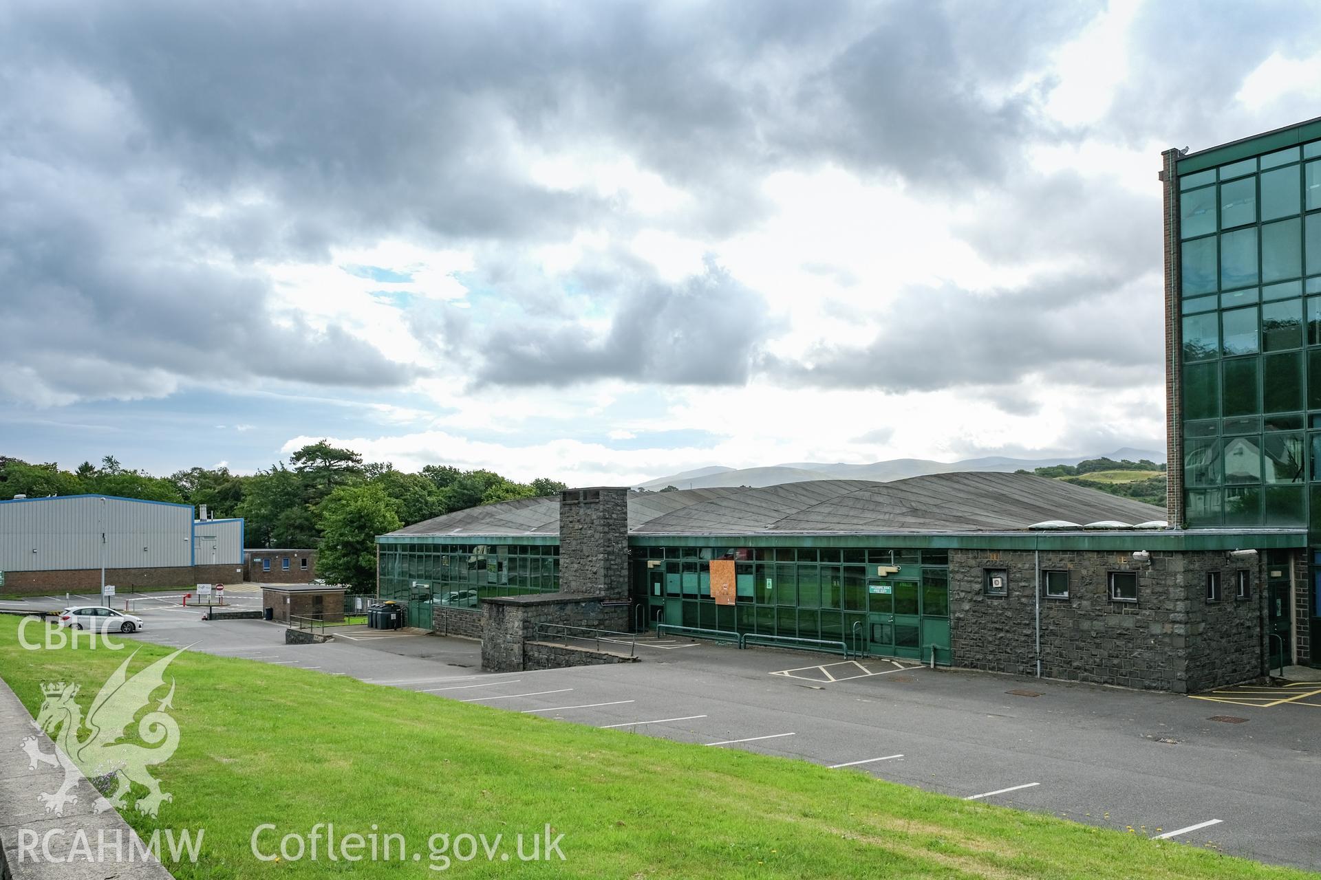 Digital colour photograph showing wide exterior view from road of Caernarfonshire Technical College, Ffriddoedd Road, Bangor. Photographed by Dilys Morgan and donated by Wyn Thomas of Grwp Llandrillo-Menai Further Education College, 2019.