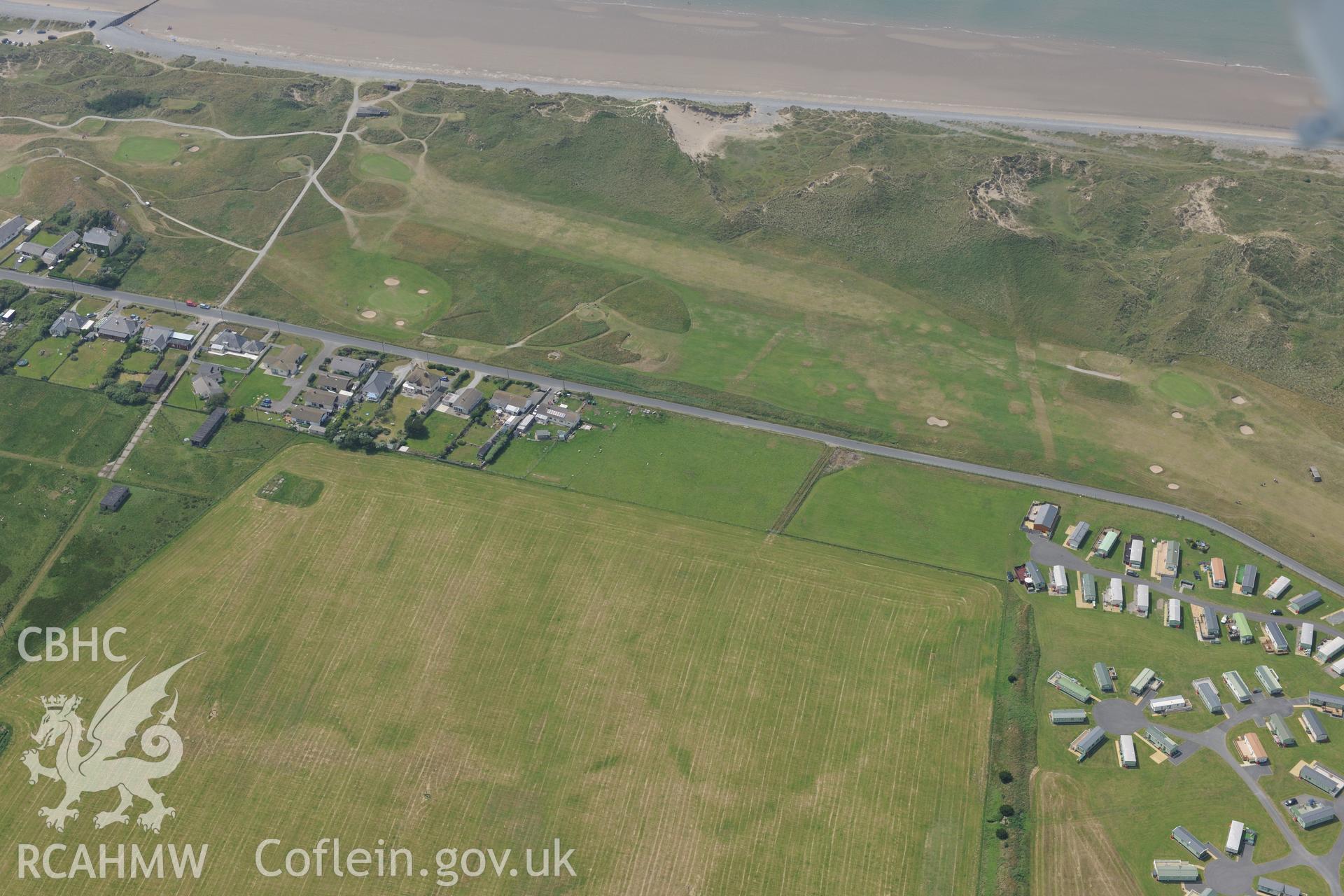 Ynyslas rocket range and the village of Ynys Las, Ceredigion. Oblique aerial photograph taken during the Royal Commission?s programme of archaeological aerial reconnaissance by Toby Driver on 12th July 2013.