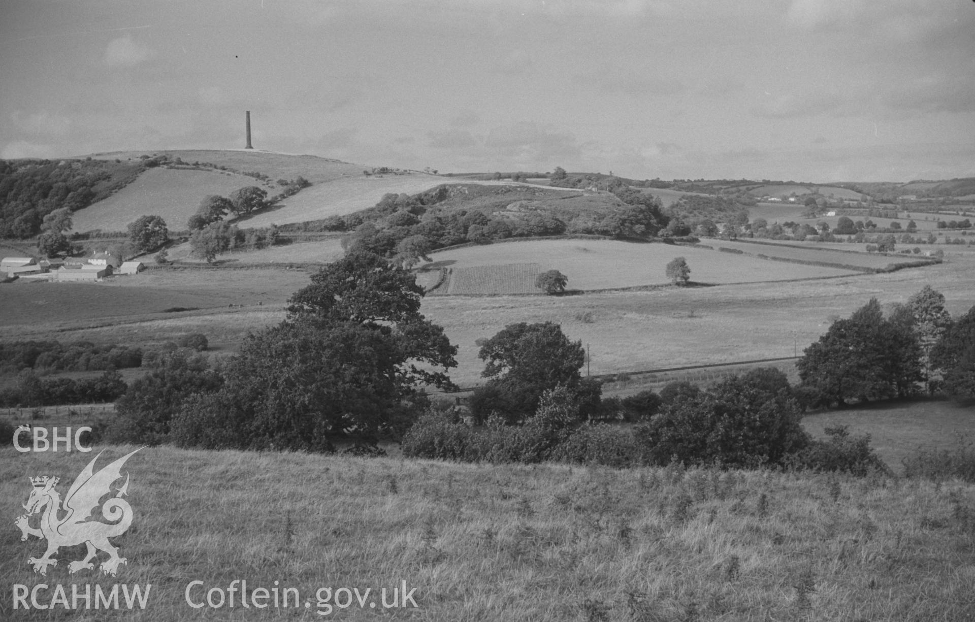 Digital copy of a black and white negative showing panoramic view of Glan Denys, Derry Ormond Monument, Dulas valley and woods by Castell Goetre. Photographed by Arthur O. Chater on 4th September 1966 from Grid Reference SN 591 505. (Photograph 3 of 6).