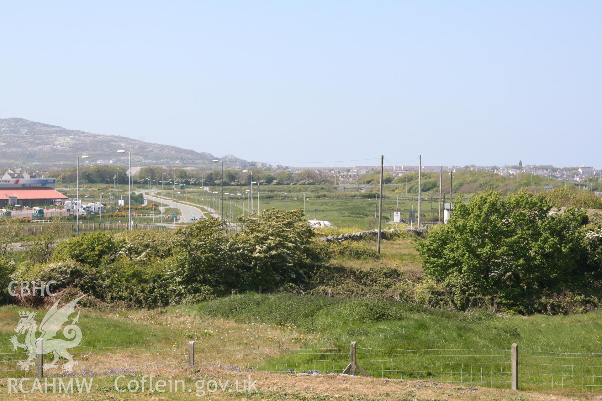 Shot, using slight camera zoom, towards Ty-Mawr Standing Stone and the development site. Looking northwest. Digital photograph taken for archaeological work at Parc Cybi Enterprise Zone, Holyhead, carried out by Archaeology Wales, 2017. Project no: P2522.