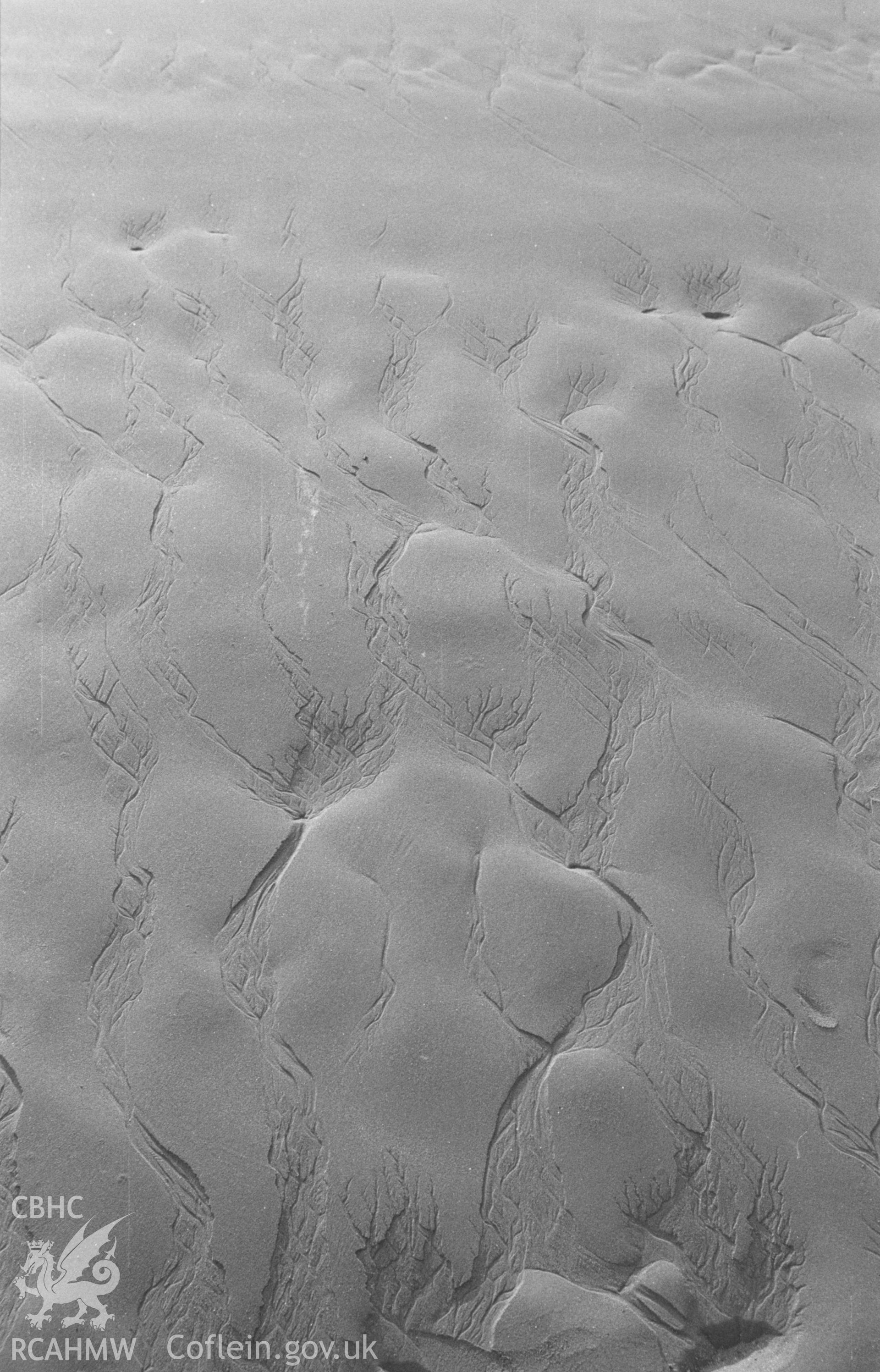 Digital copy of a black and white negative showing sand patterns on Poppit Sands, Cardigan. Photographed in December 1963 by Arthur O. Chater from Grid Reference c. SN 156 488.