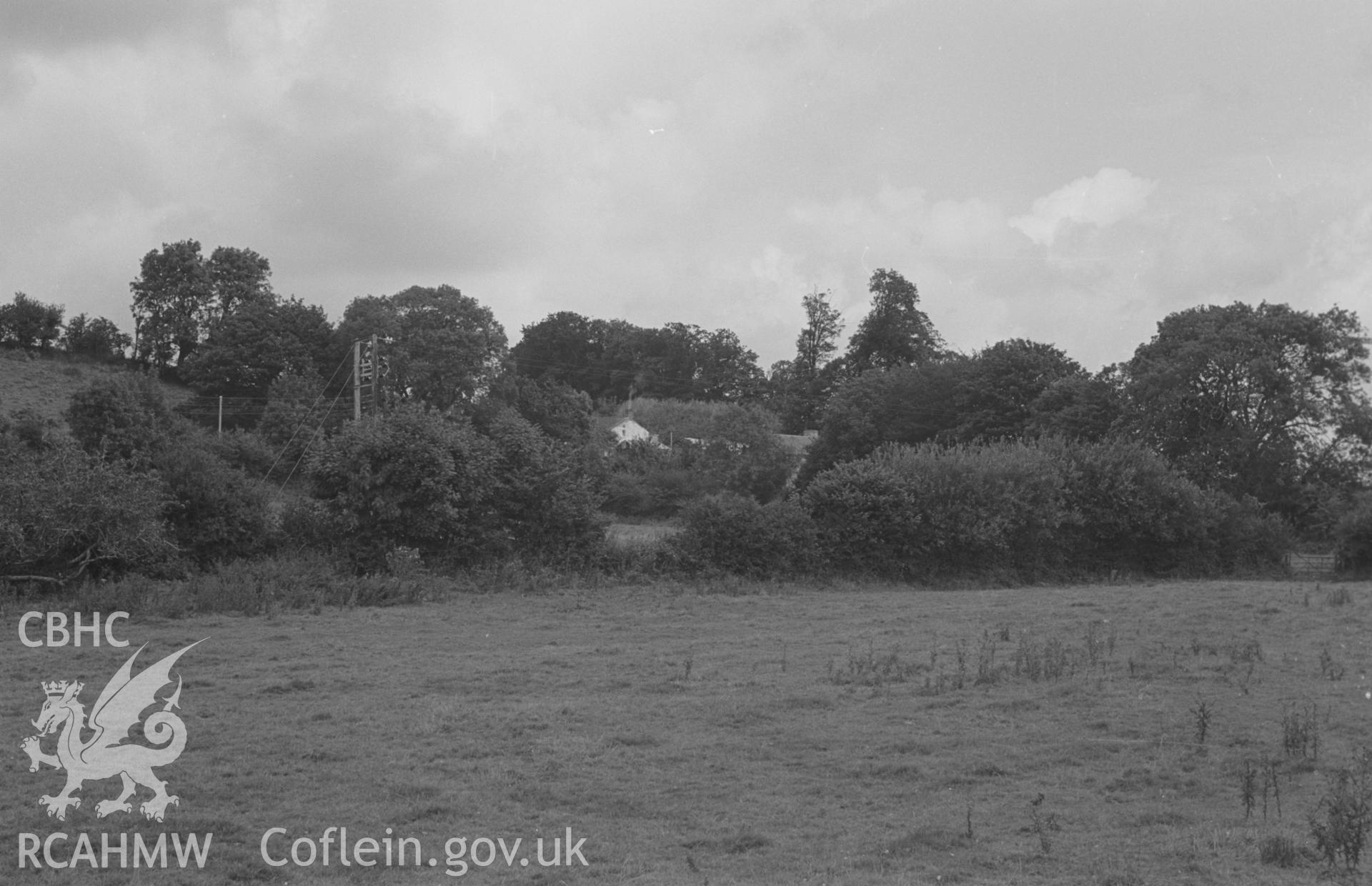 Digital copy of a black and white negative showing view of Castell Dol-Wlff Norman motte, from the road just south of Highmead Arms. Photographed in September 1963 by Arthur O. Chater from Grid Reference SN 5190 4432, looking north east.