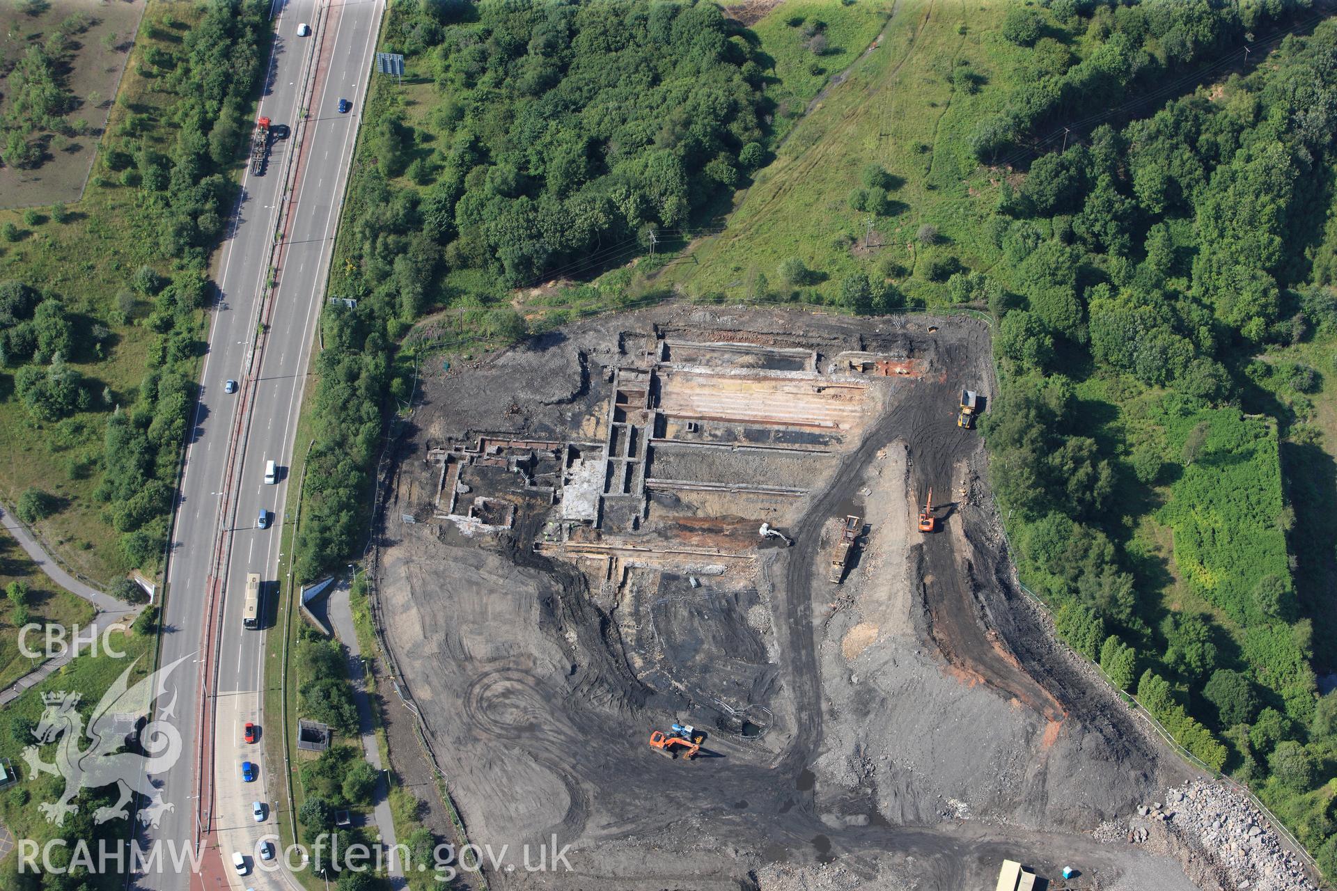 Site of former Rotax factory, and Cyfarthfa Ironworks including the remains of its blast furnaces, under excavation by Glamorgan-Gwent Archaeological Trust. Oblique aerial photograph taken during the Royal Commission?s programme of archaeological aerial reconnaissance by Toby Driver on 1st August 2013.