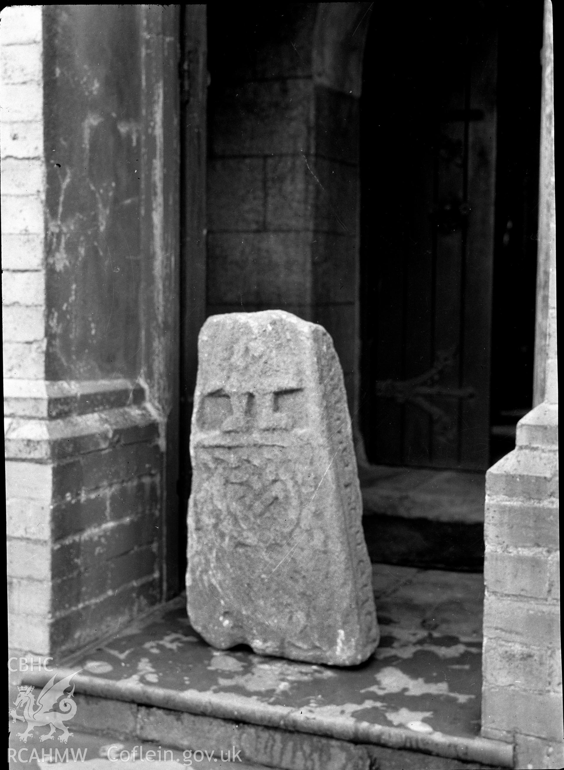 Digital copy of a nitrate negative showing an inscribed stone in the chapel on Bardsey Island. From the Cadw Monuments in Care Collection.