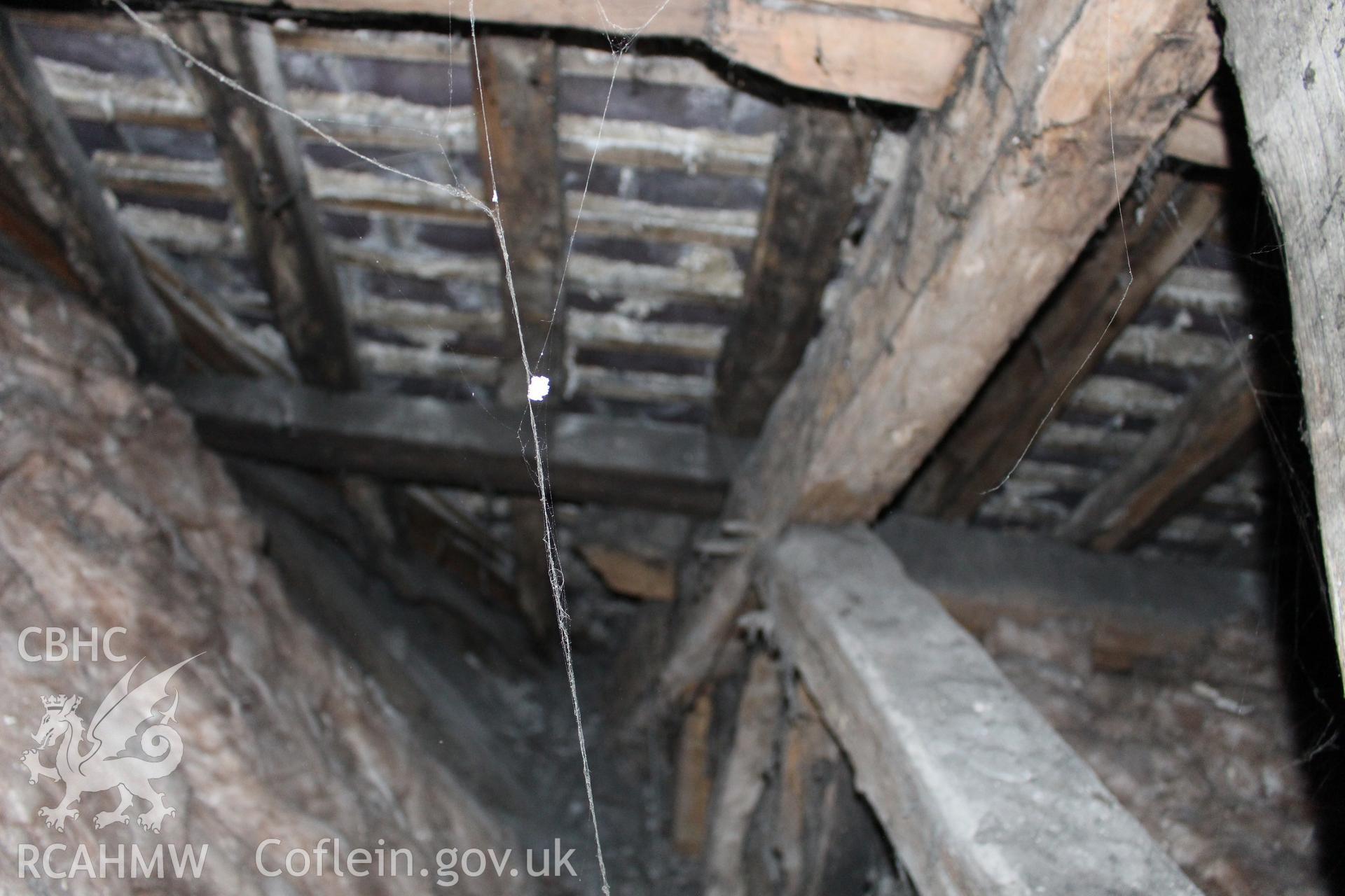 Colour photograph showing detail of insulating wool and timber roof frame at 5-7 Mwrog Street, Ruthin. Photographed during survey conducted by Geoff Ward on 14th May 2014.
