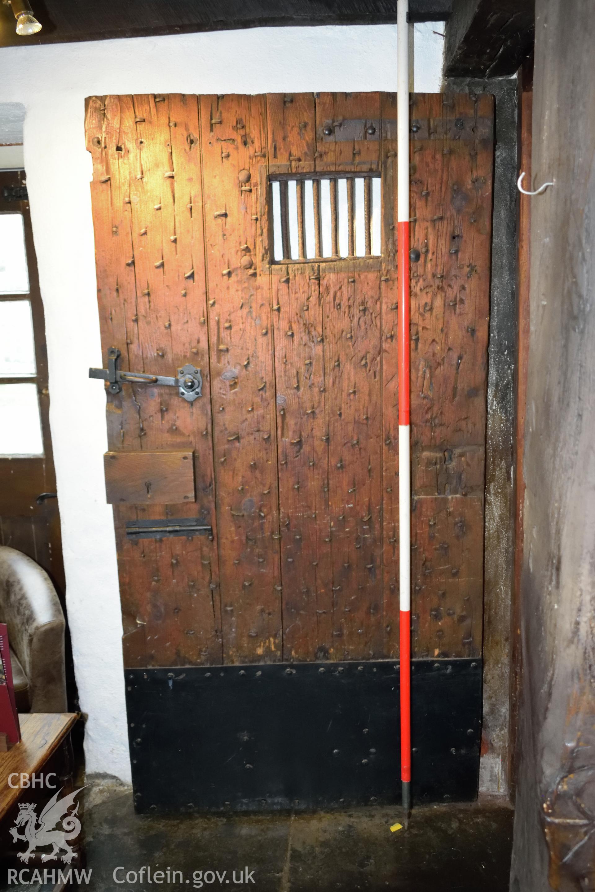 Colour photograph showing view looking south at the door at the base of the stairs of Y Sospan, Llys Owain, Dolgellau. Photographed by I. P. Brookes of Engineering Archaeological Services, June 2019.