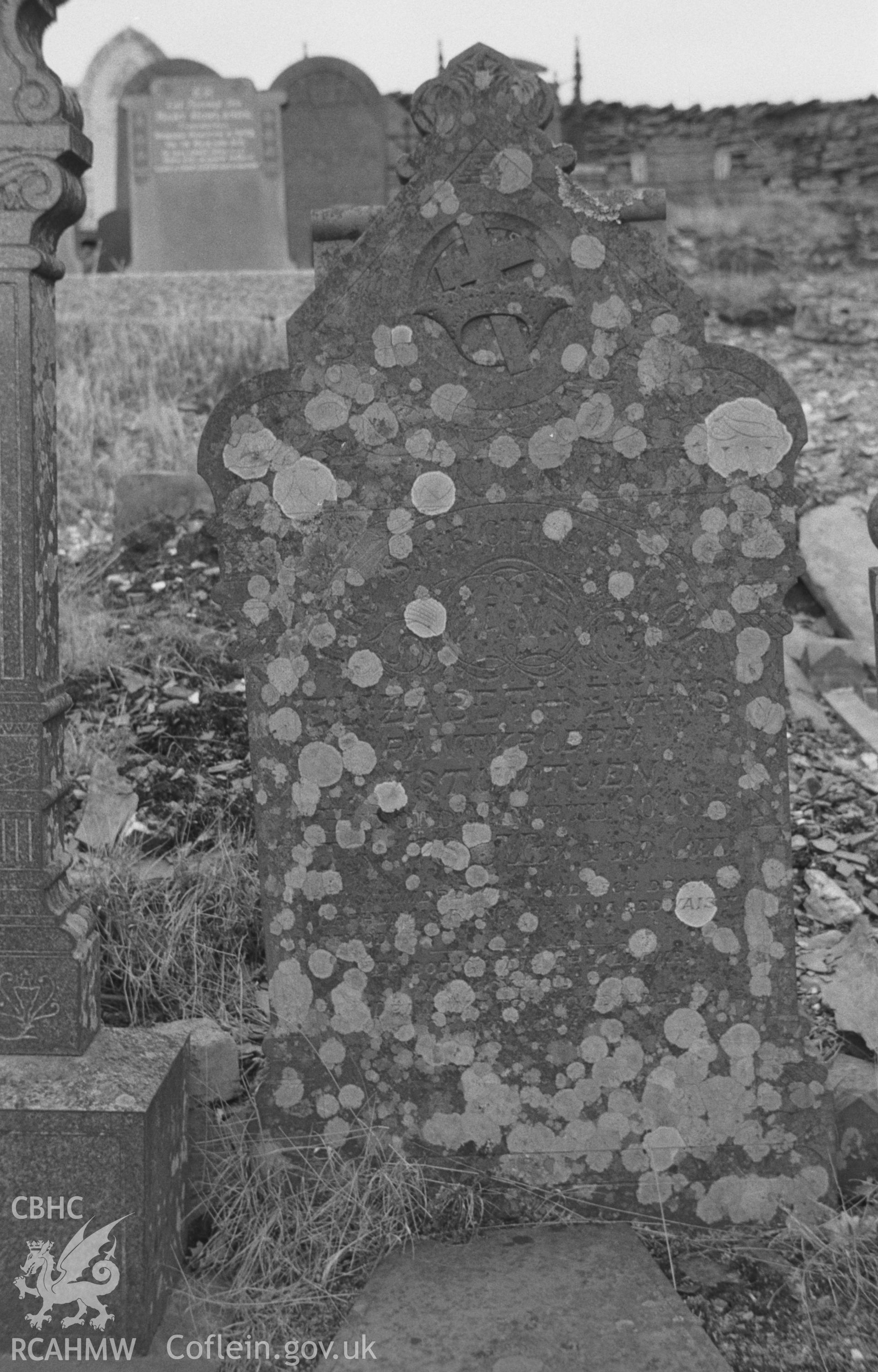 Digital copy of a black and white negative showing tombstones in the graveyard at Ystumtuen Methodist Chapel. Photographed by Arthur O. Chater in April 1966 from Grid Reference SN 735 786, looking west and south west.