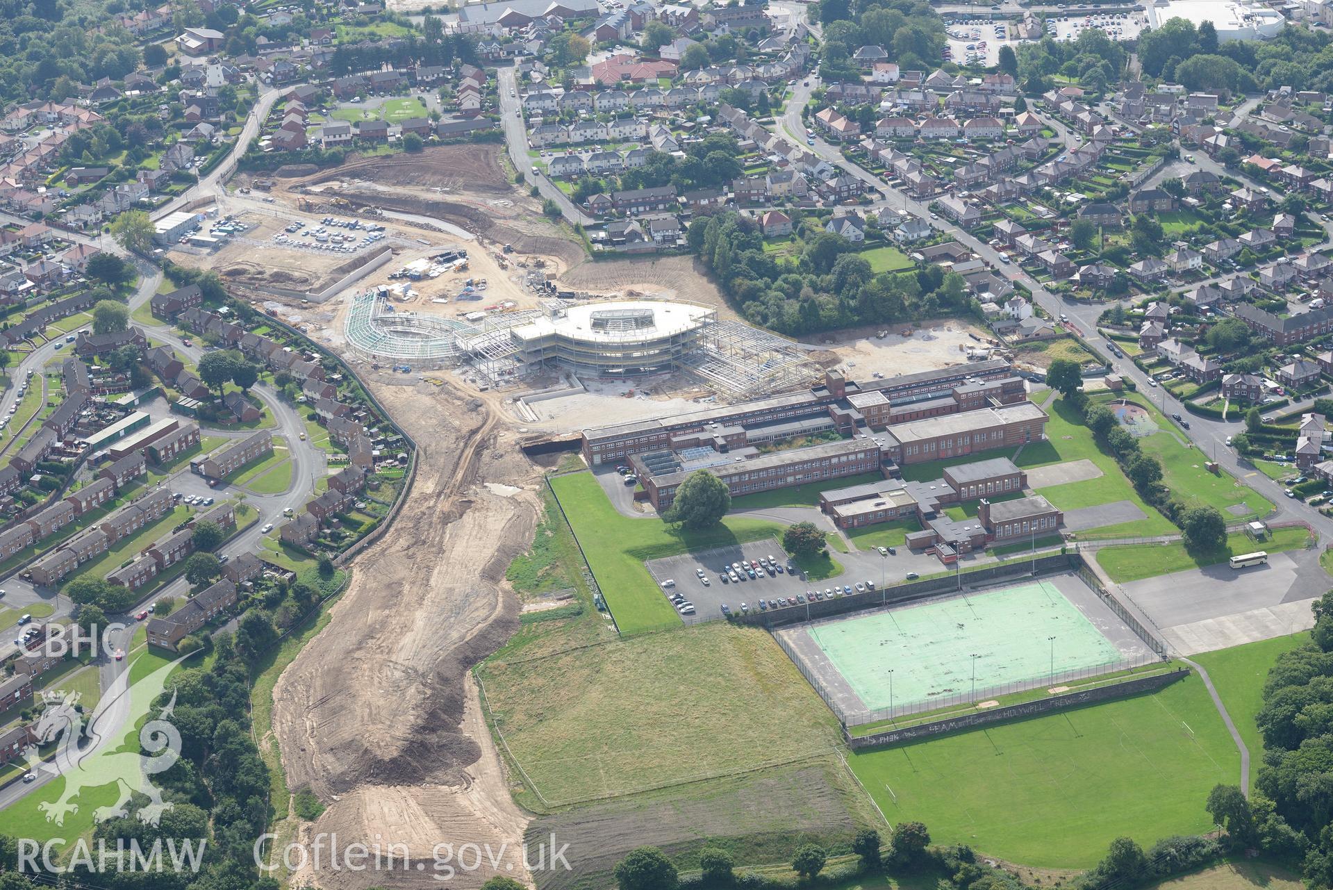 Holywell High School, with Ysgol Treffynon and Ysgol Maes y Felin under construction behind. Oblique aerial photograph taken during the Royal Commission's programme of archaeological aerial reconnaissance by Toby Driver on 11th September 2015.