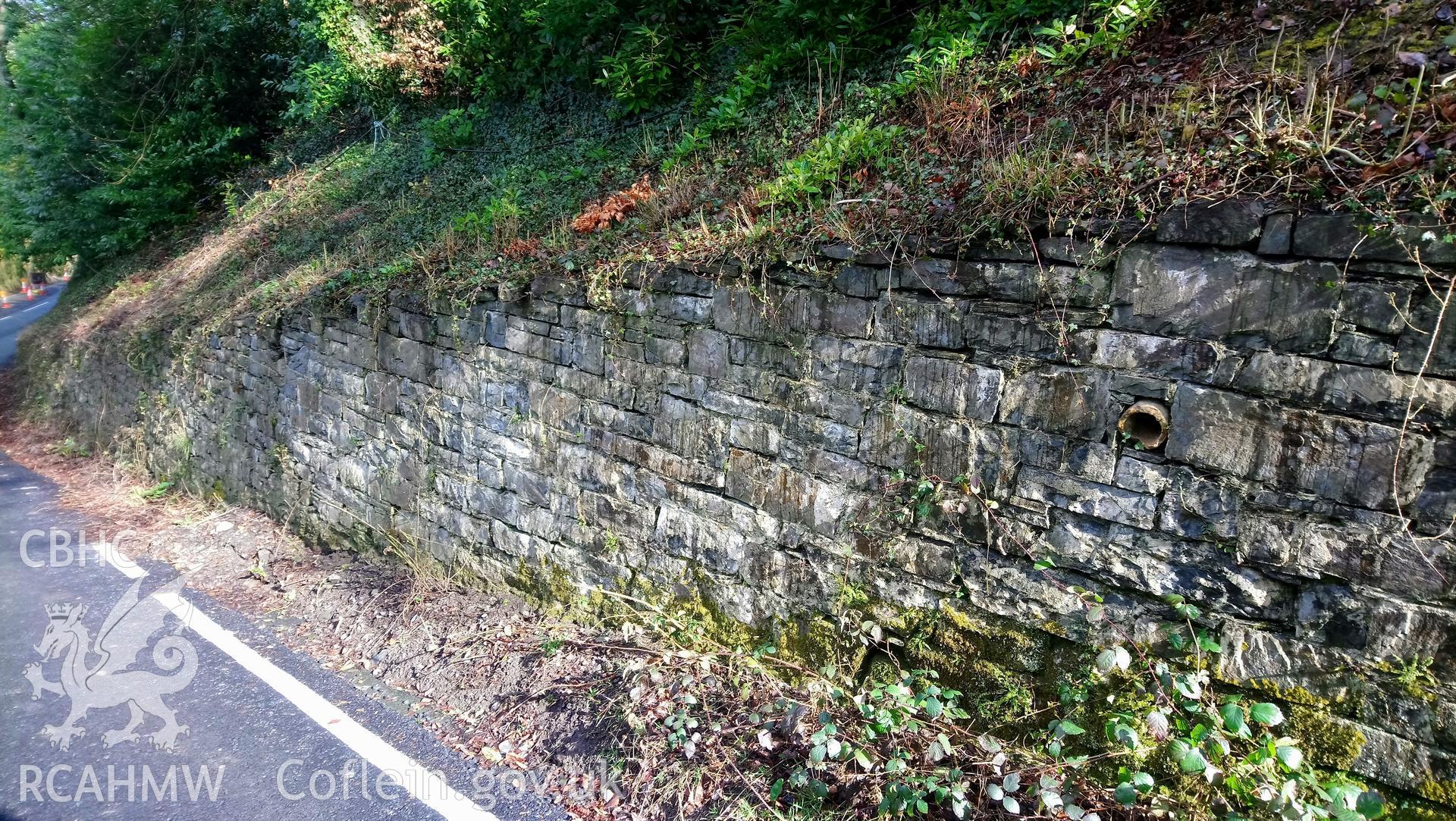 Photographs taken on 15th March 2018 of historic retaining wall at Castle Hill, Llanilar, built of local sandstone blocks closely replicating the appearance of the original Roman walls of the Abermagwr Roman villa which were built of the same stone.