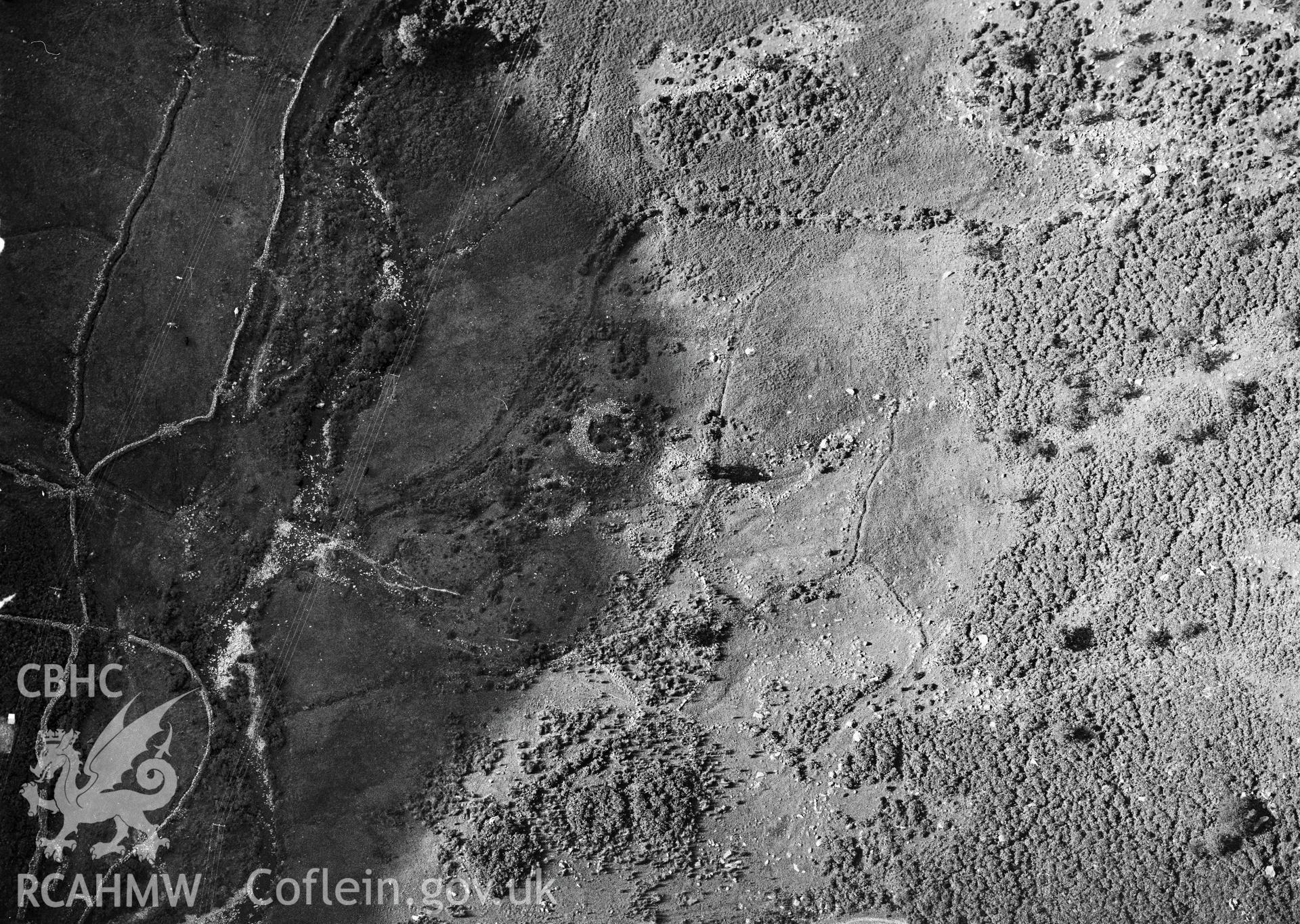 RCAHMW Black and white oblique aerial photograph of the hut circle settlement north of Cwm Dyli Power Station, Beddgelert, taken on 20/08/1999 by Toby Driver