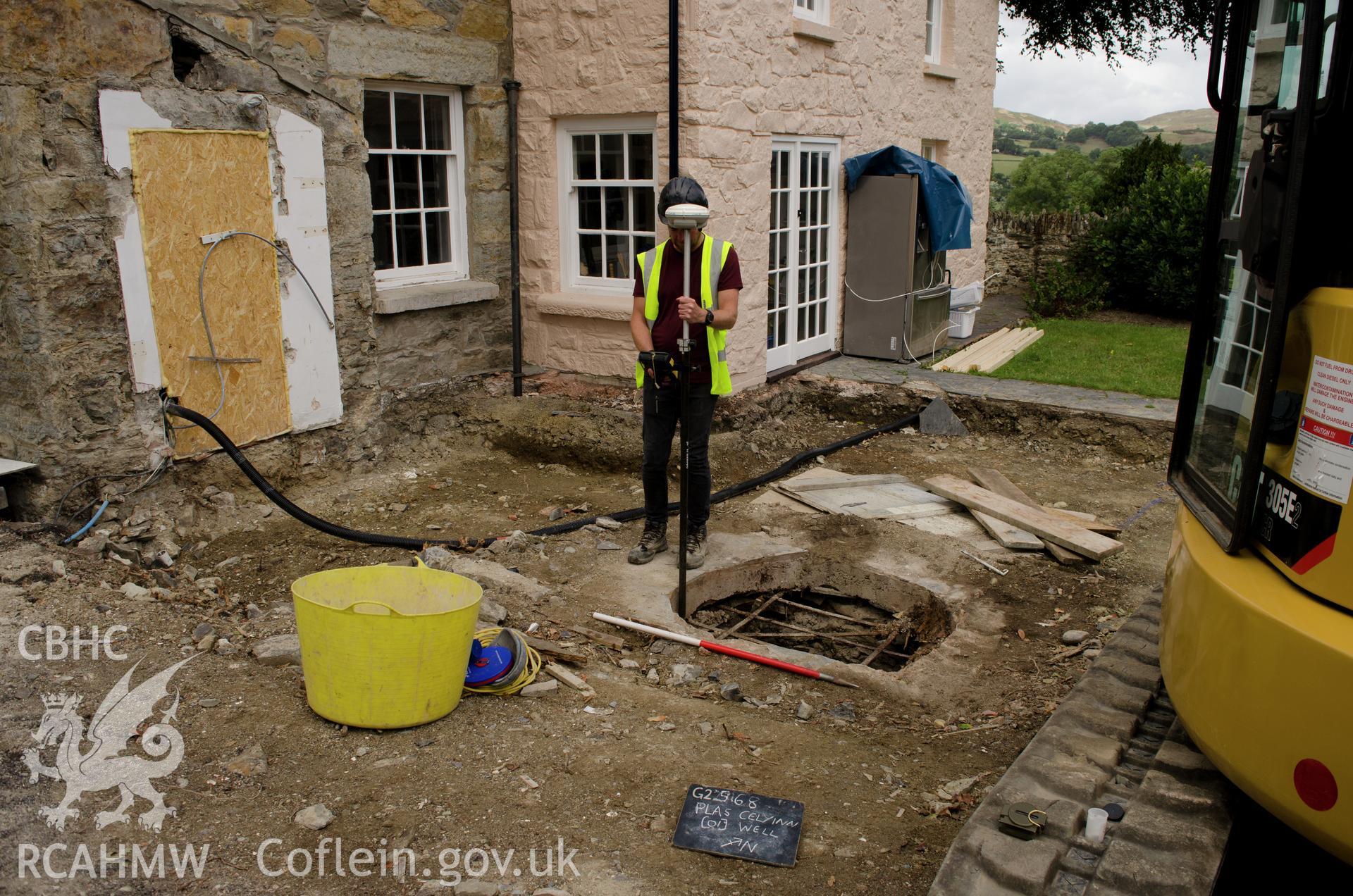 'Location shot of the well, view from the east.' Photographed by Gwynedd Archaeological Trust as part of archaeological mitigation report for well at Plas Celynin, Henryd, Conwy, on 1st August 2018. Project no. G2568.