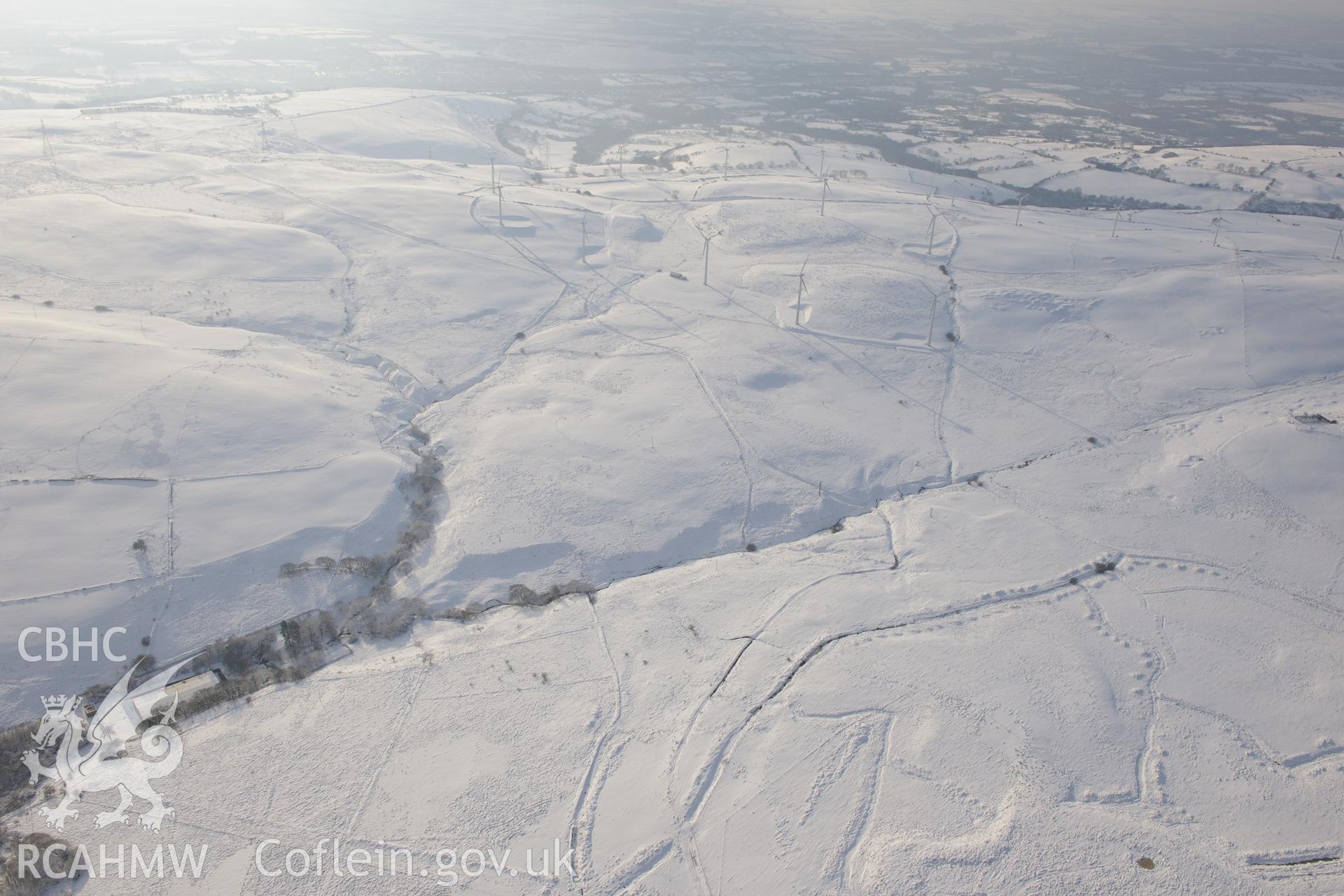 View from the north east of Taff-Ely wind farm, Mynydd Maendy, north east of Bridgend. Oblique aerial photograph taken during the Royal Commission?s programme of archaeological aerial reconnaissance by Toby Driver on 24th January 2013.