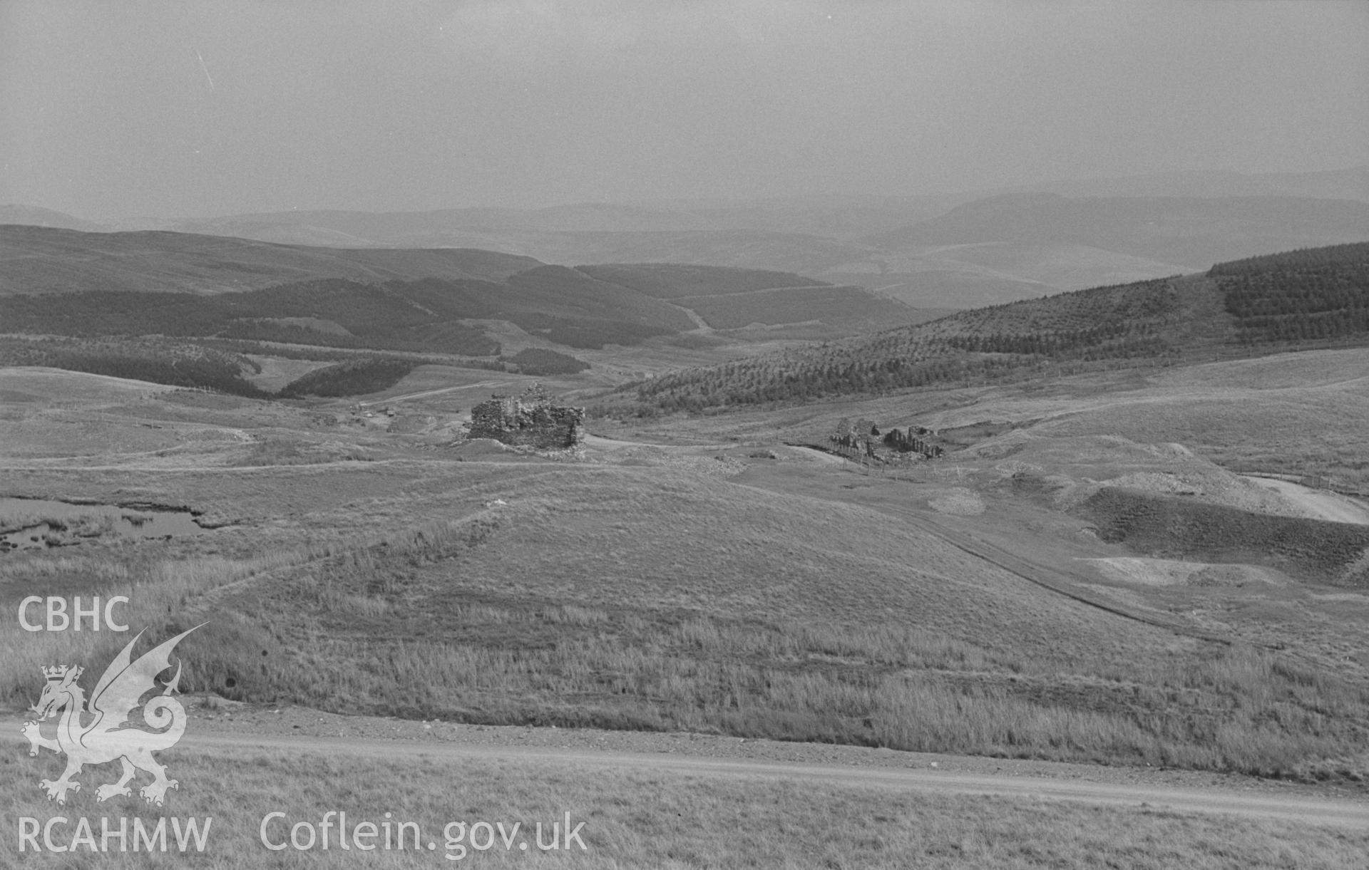 Digital copy of a black and white negative showing Esgair Hir lead mine from Banc Bwlchgarreg; Esgair-Fraith mine lower down valley in distance. Photographed by Arthur O. Chater on 22nd August 1967, looking east from Grid Reference SN 732 913.