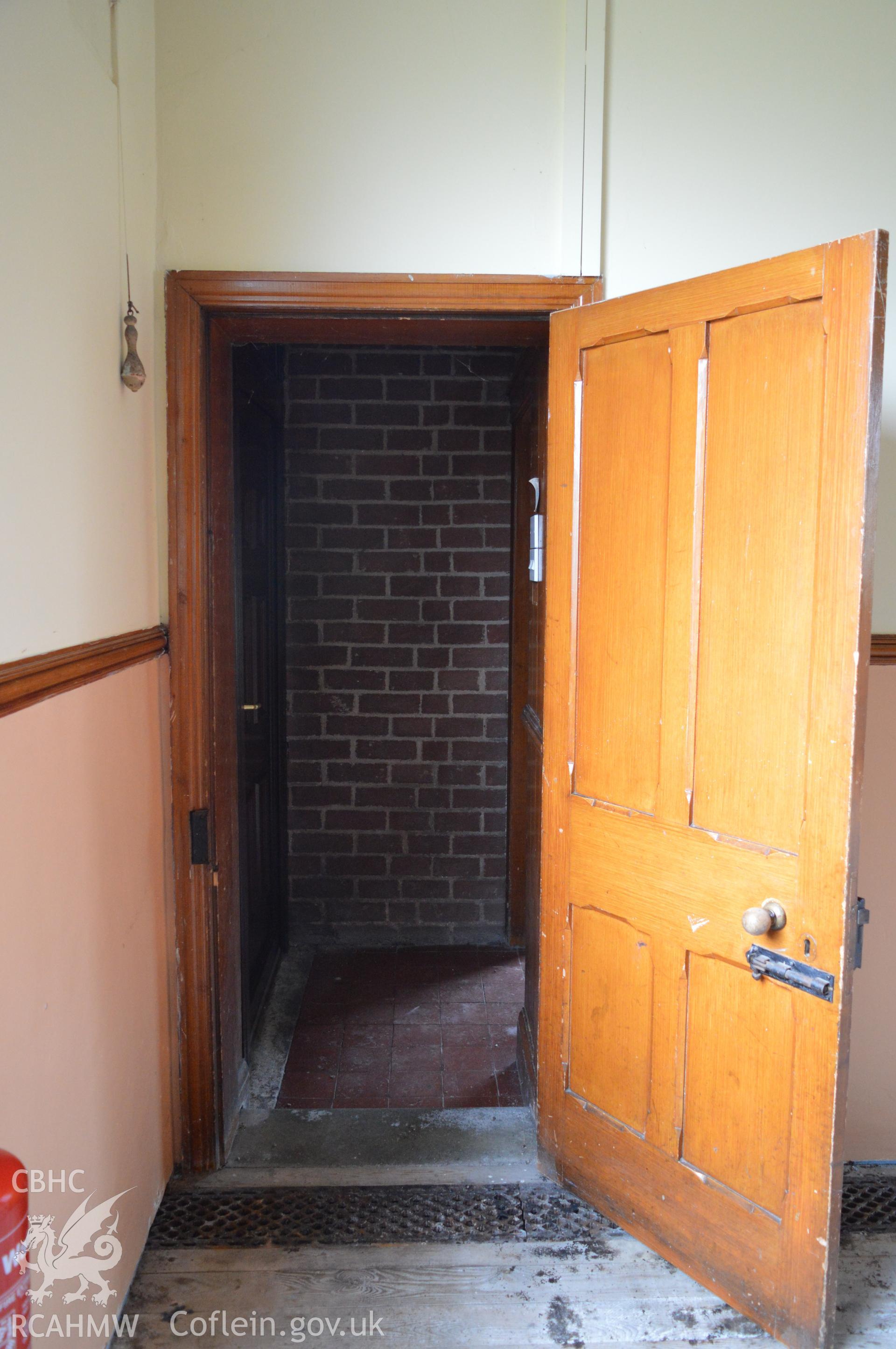 Internal view down the passage from the eastern room to the kitchen. Digital colour photograph taken during CPAT Project 2396 at the United Reformed Church in Northop. Prepared by Clwyd Powys Archaeological Trust, 2018-2019.