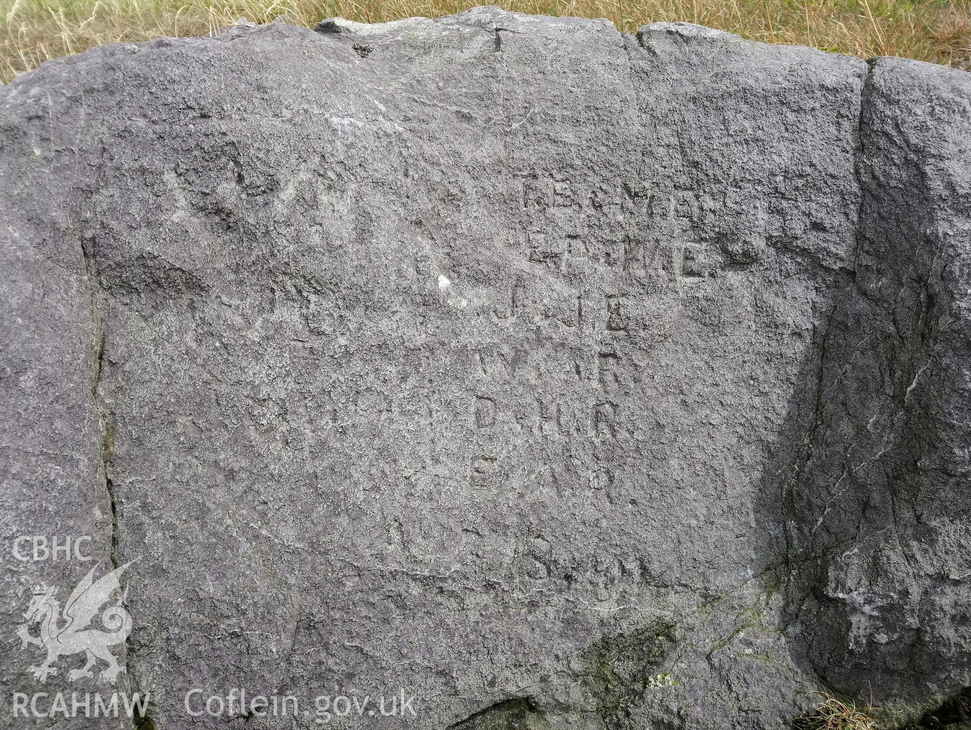 Investigator's photography of an inscribed stone on the summit of Plynlimon