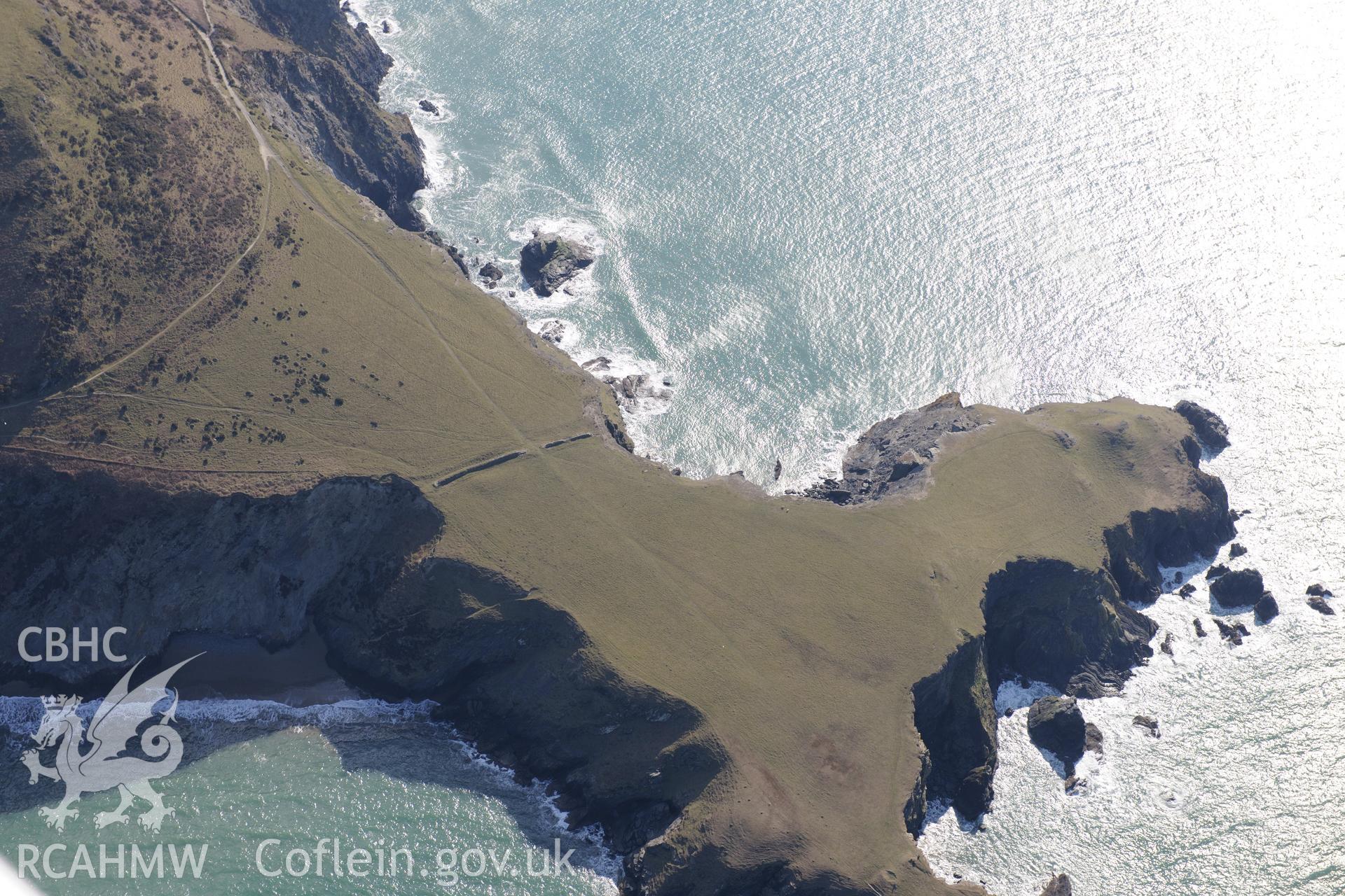 Ynys Lochtyn defended enclosure, on the coast north of Llangrannog. Oblique aerial photograph taken during the Royal Commission's programme of archaeological aerial reconnaissance by Toby Driver on 2nd April 2013.