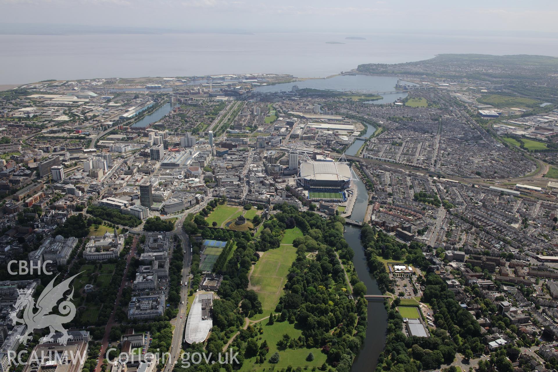 Views of Cardiff including the Bay, Millennium Stadium, Castle and grounds and Welsh College of Music and Drama. Oblique aerial photograph taken during the Royal Commission's programme of archaeological aerial reconnaissance by Toby Driver on 29/6/2015.