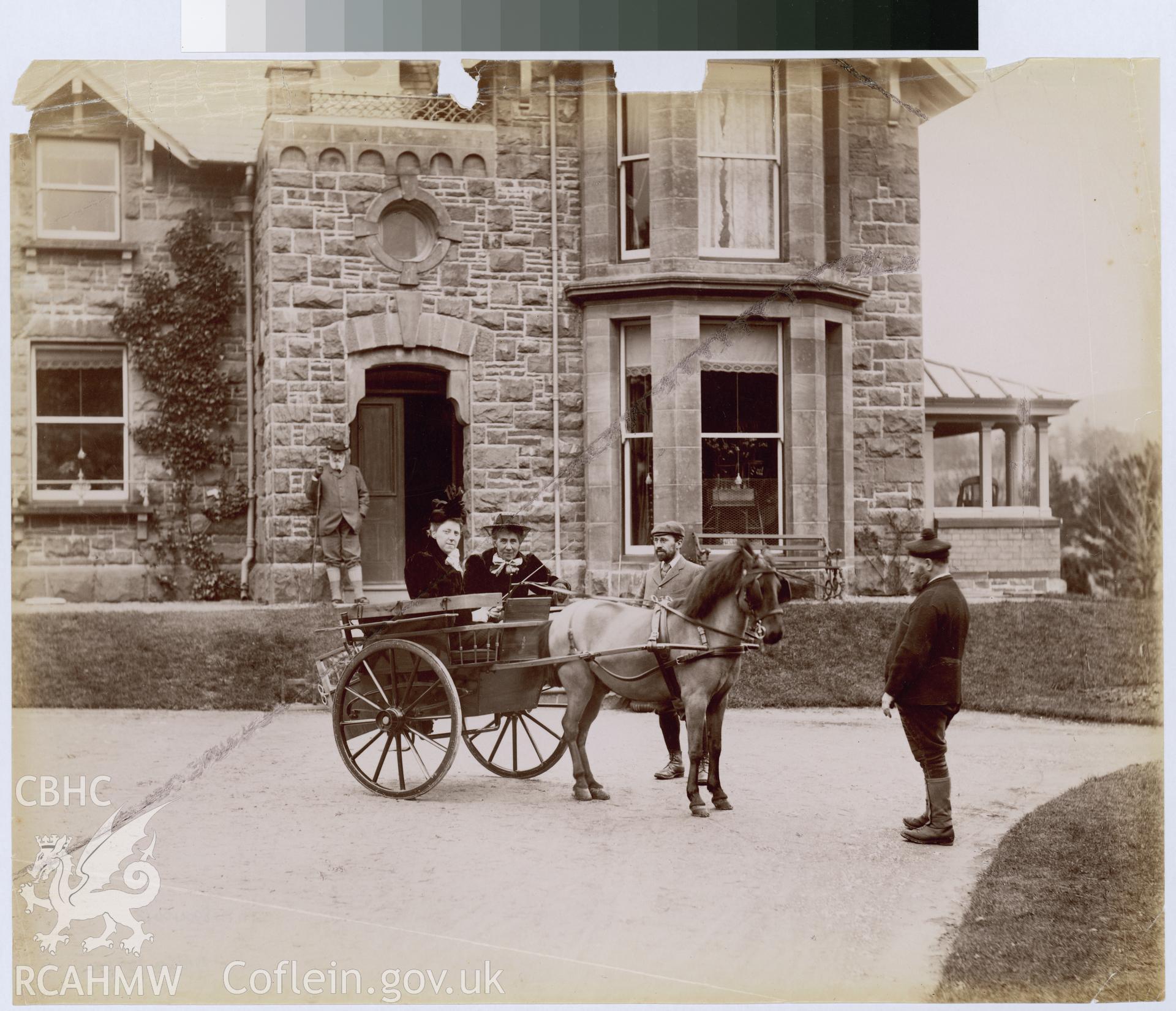 Digital copy of an albumen print from Edward Hubbard Collection showing pony and trap with passengers outside house.