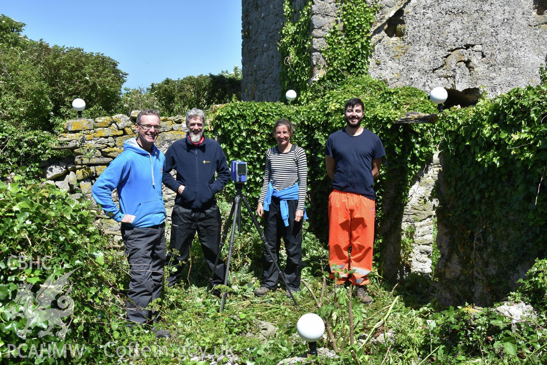 Investigator's photographic survey of the church on Puffin Island or Ynys Seiriol for the CHERISH Project. View showing CHERISH Project staff undertaking survey work. ? Crown: CHERISH PROJECT 2018. Produced with EU funds through the Ireland Wales Co-operation Programme 2014-2020. All material made freely available through the Open Government Licence.