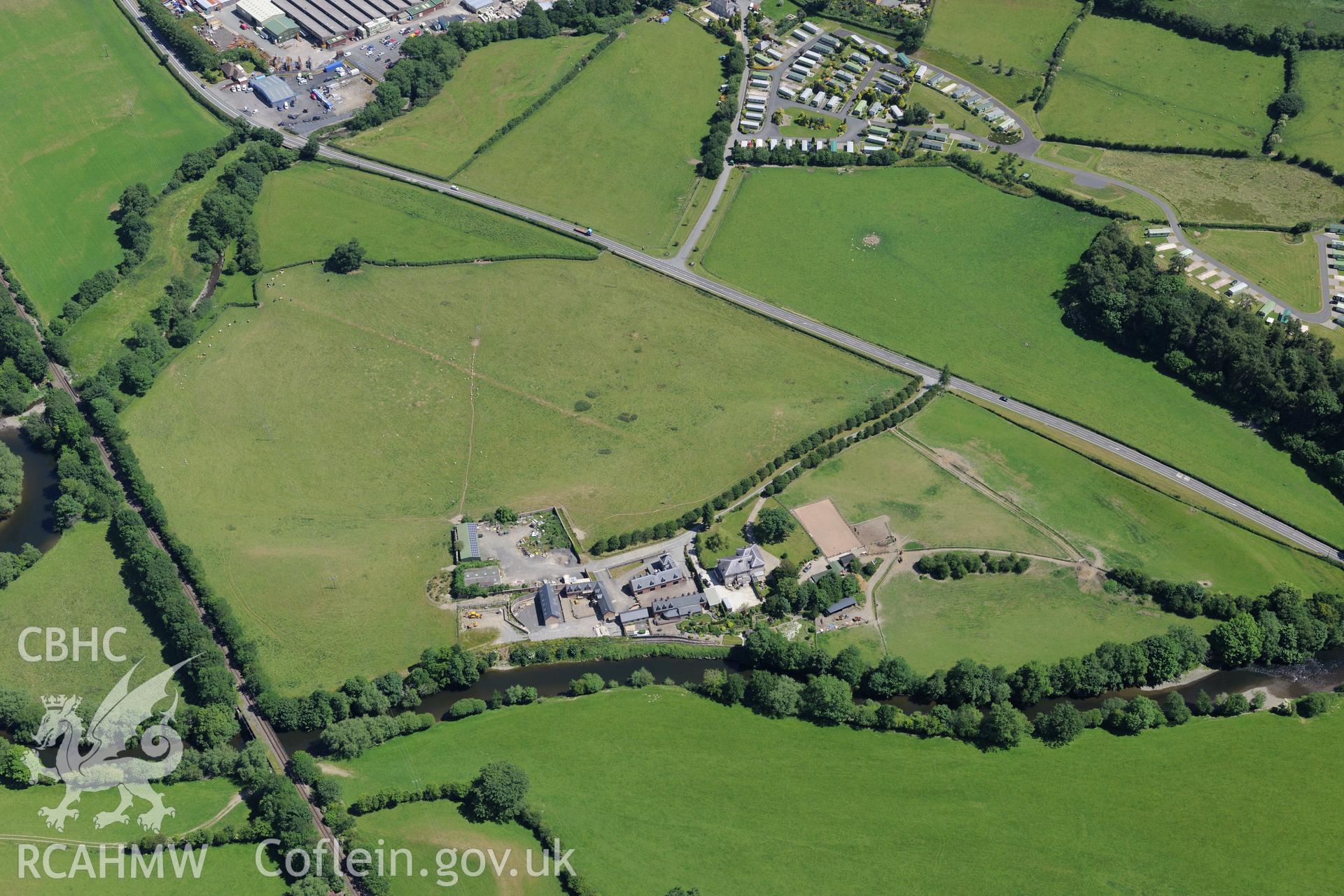 Glanhafren house and garden, and the Roman road which runs through its grounds, west of Newtown. Oblique aerial photograph taken during the Royal Commission's programme of archaeological aerial reconnaissance by Toby Driver on 30th June 2015.