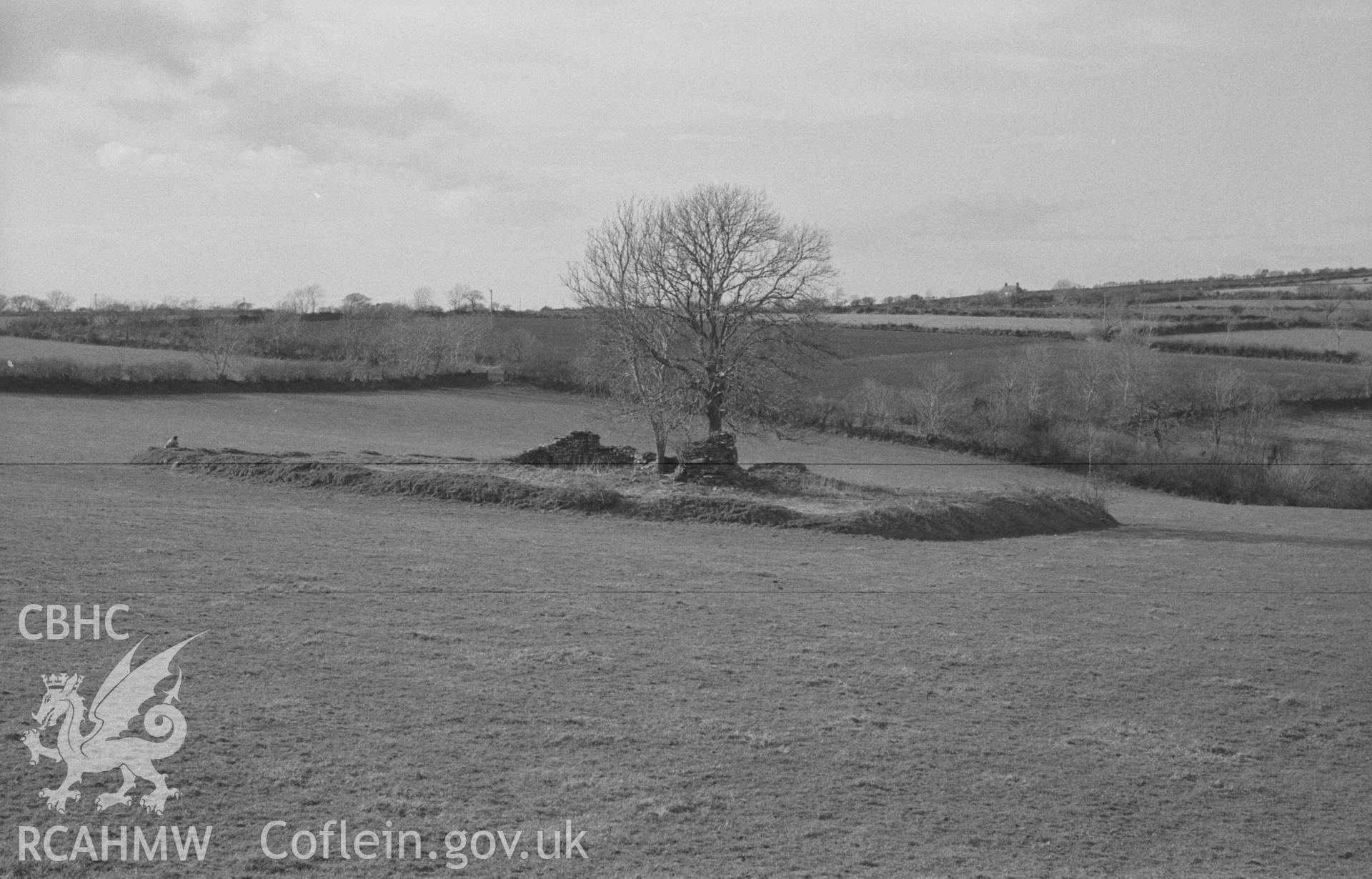 Digital copy of a black and white negative showing site of St Mary's church, Llanfair Trefhelygen. Photographed in April 1963 by Arthur O. Chater from Grid Reference SN 3443 4408, looking north west.