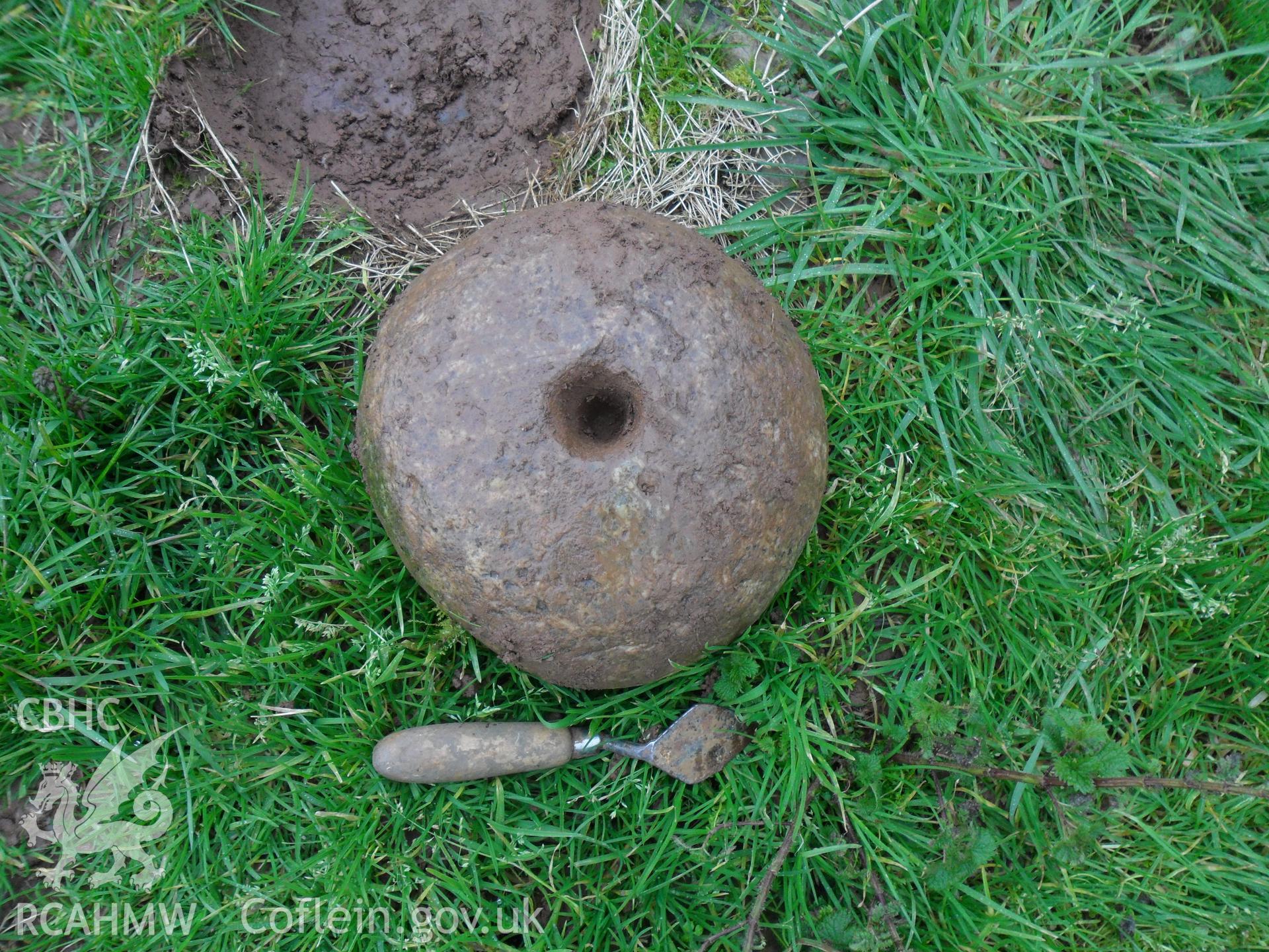 Digital colour photograph of find at Maes Gwenllian battlefield. From report no. 1050 - Maes Gwenllian battlefield, part of the Welsh Battlefield Metal Detector Survey, carried out by Archaeology Wales.