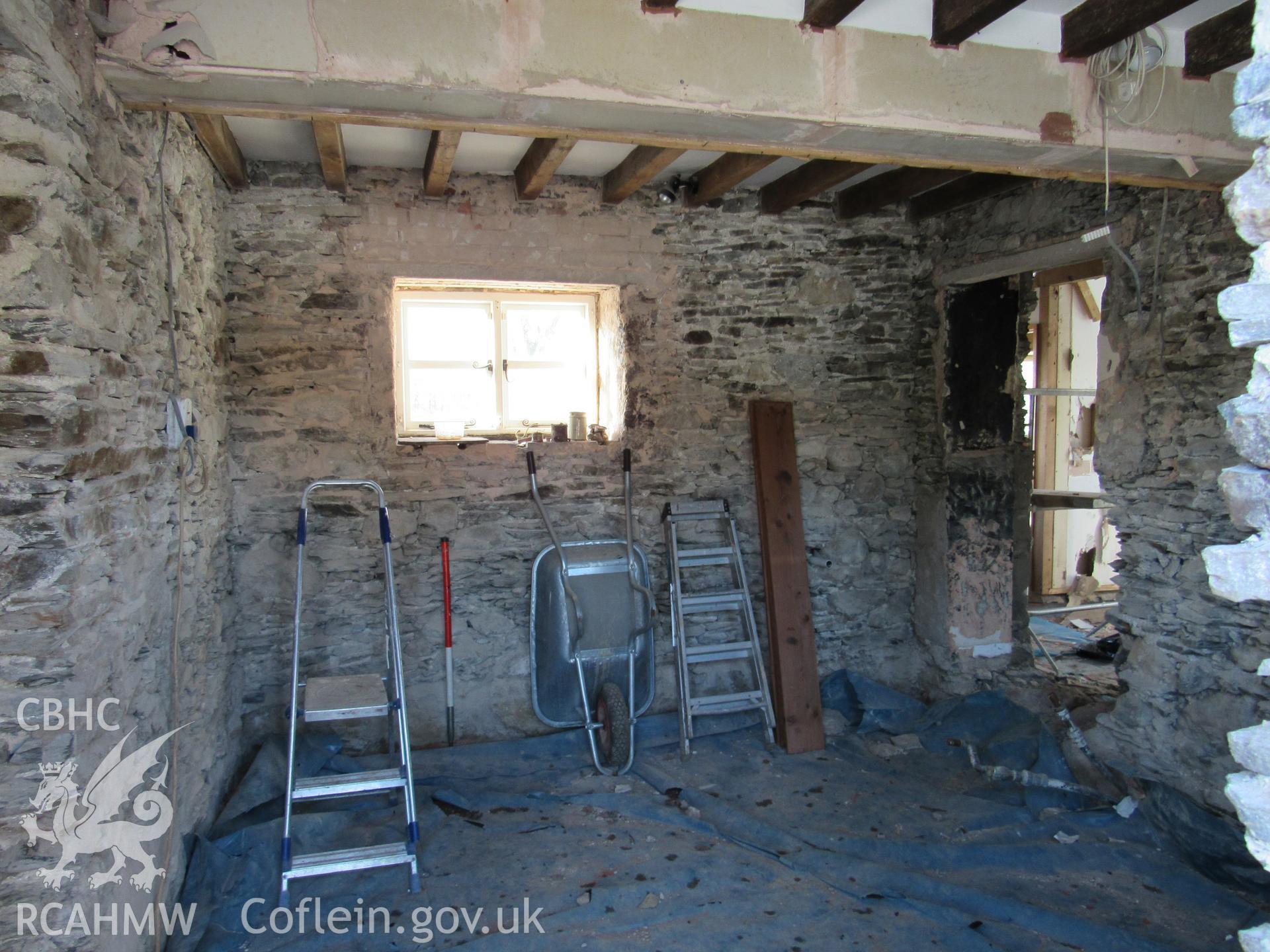 Kitchen in original house with inserted doorway to modern extension, view south-west. Photographed for archaeological building recording conducted at Bryn Ysguboriau, Llanelidan, Denbighshire, carried out by Archaeology Wales, 2018. Project no. P2587.