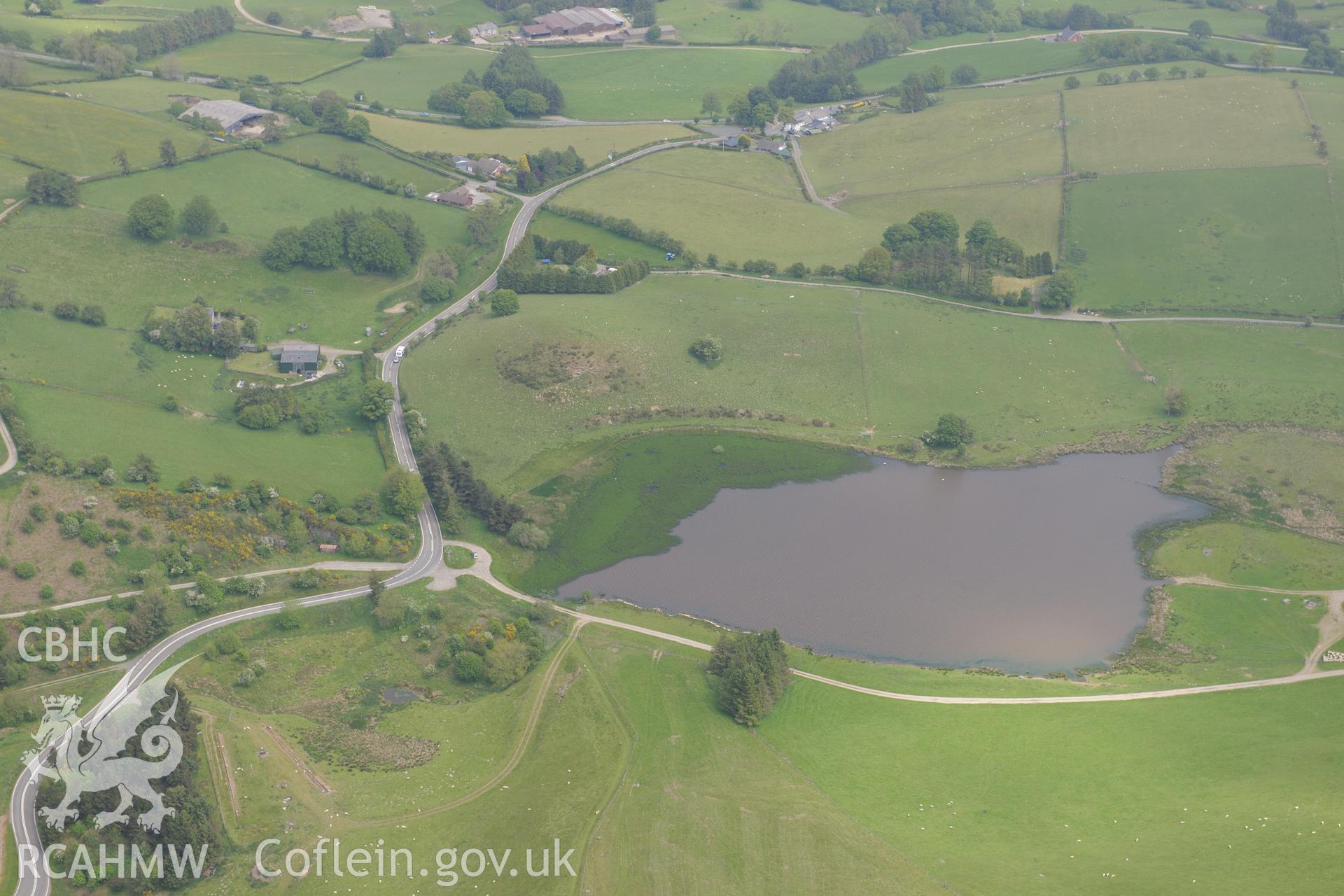Pool Farmstead, house and farmbuildings, plus Llynheilyn lake. Oblique aerial photograph taken during the Royal Commission's programme of archaeological aerial reconnaissance by Toby Driver on 11th June 2015.
