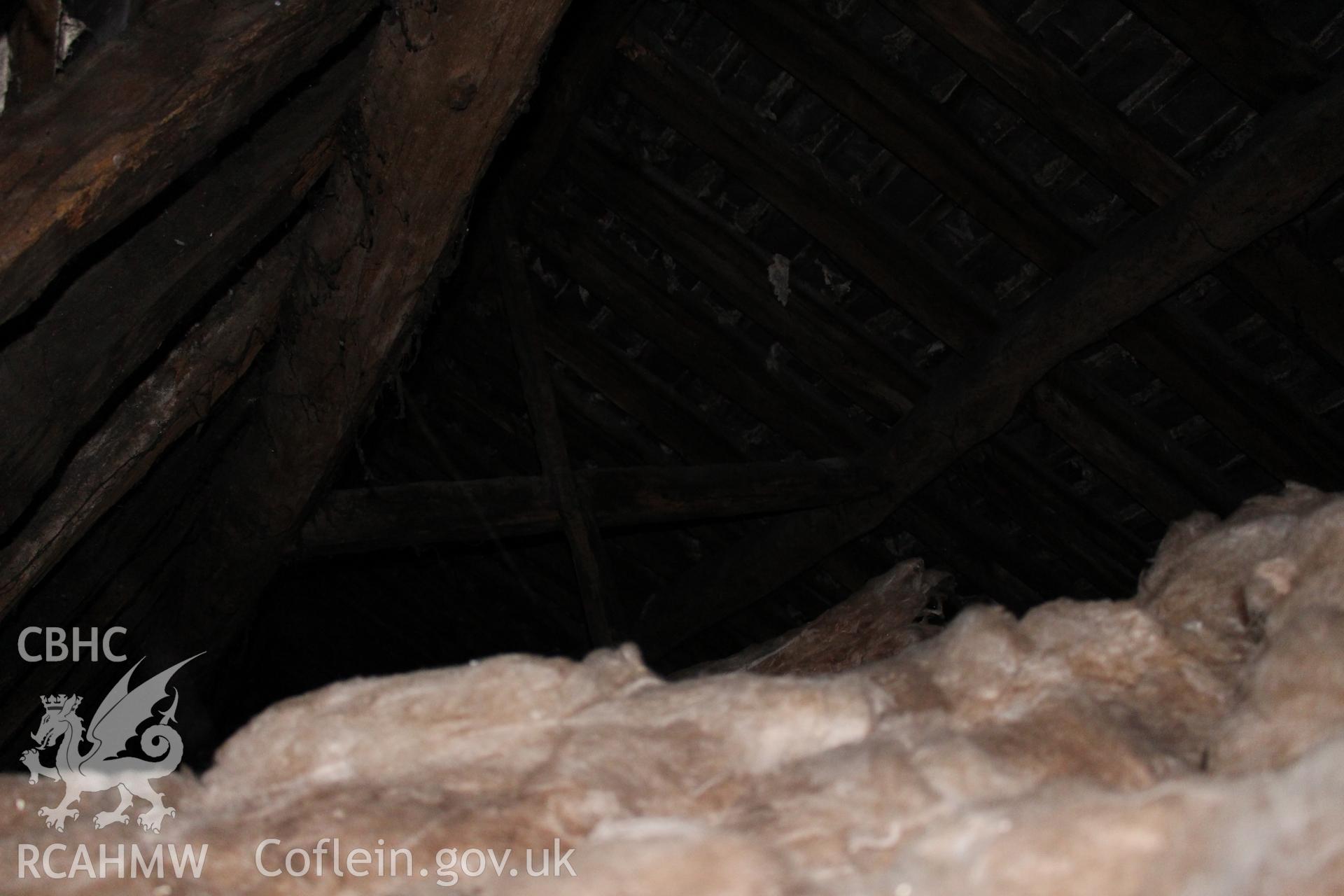 Colour photograph showing detail of insulating wool and timber roof frame at 5-7 Mwrog Street, Ruthin. Photographed during survey conducted by Geoff Ward on 14th May 2014.