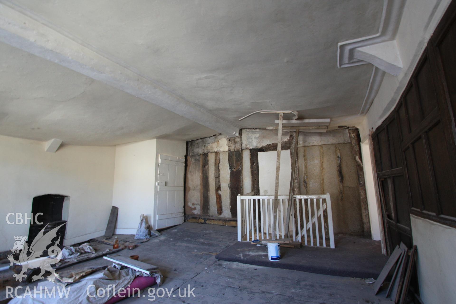 Colour photograph showing interior view of first floor chamber of cross-wing, timber frame and plastered wall at Porth-y-Dwr, 67 Clwyd Street, Ruthin. Photographed during survey conducted by Geoff Ward on 10th June 2013.