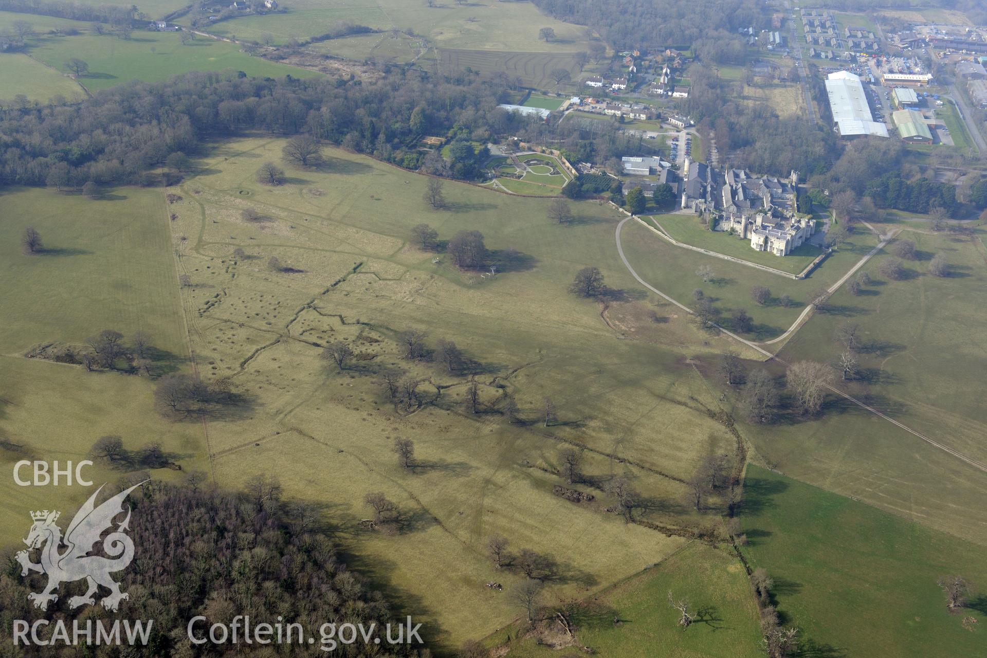 Bodelwyddan Castle, its garden, and Bodelwyddan Park army practise trenches, west of St. Asaph. Oblique aerial photograph taken during the Royal Commission?s programme of archaeological aerial reconnaissance by Toby Driver on 28th February 2013.