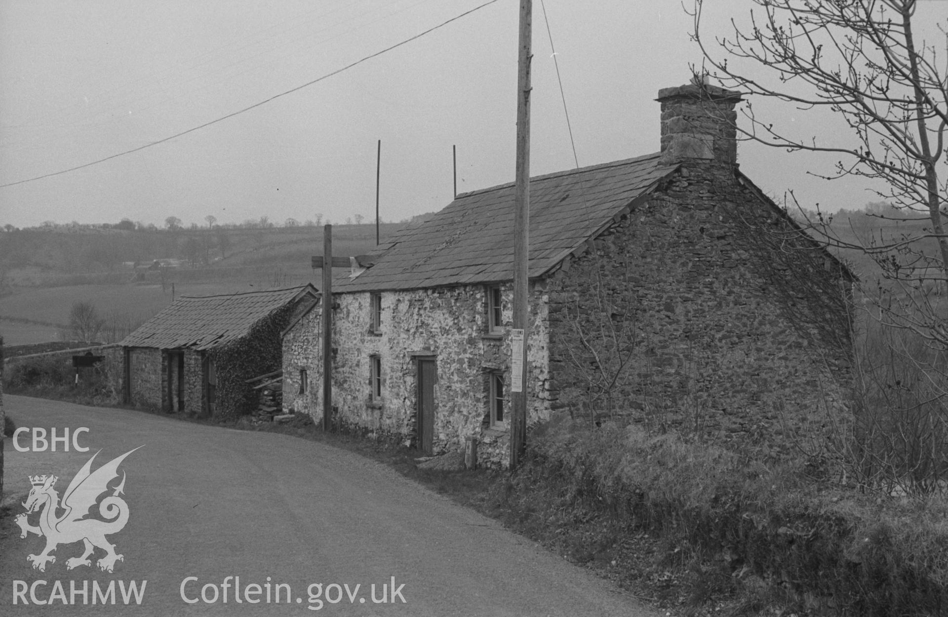 Digital copy of a black and white negative showing old house at Pont Llanfihangel, the bridge just visible on the extreme left. Photographed by Arthur O. Chater on 11th April 1967 looking south east from Grid Reference SN 456 403.