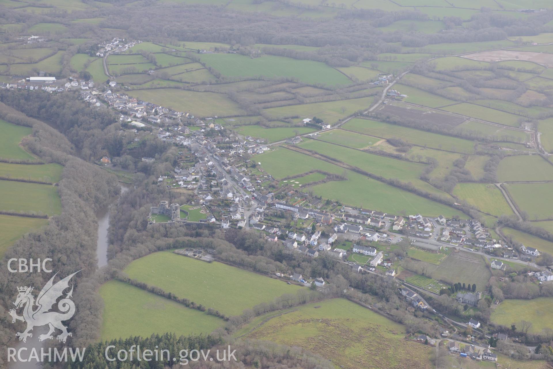 Cilgerran Castle and St Llawddog's church in the village of Cilgerran, south of Cardigan. Oblique aerial photograph taken during the Royal Commission's programme of archaeological aerial reconnaissance by Toby Driver on 13th March 2015.