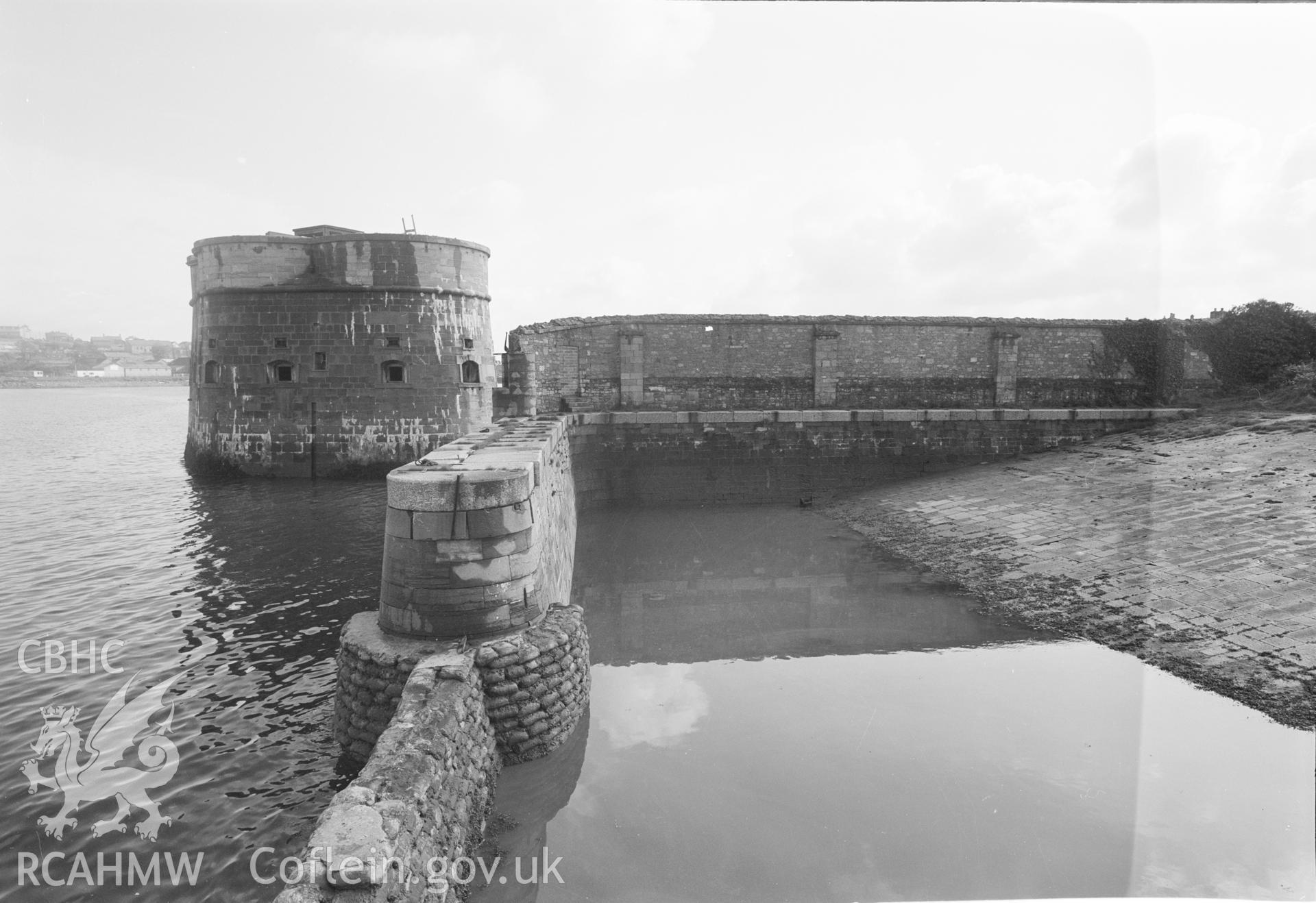 Digital copy of a black and white negative showing Old Royal Dockyard Pembroke - looking SE across slope of boat slip to NE inside corner of Dockyard Wall & NE Martello Tower taken by RCAHMW.