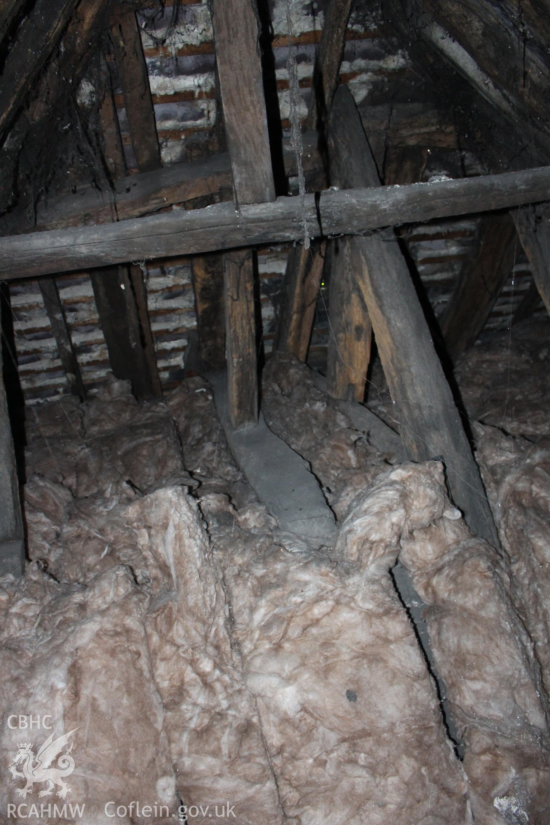 Colour photograph showing detail of insulating wool and timber roof frame at 5-7 Mwrog Street, Ruthin. Photographed during survey conducted by Geoff Ward on 14th May 2014.
