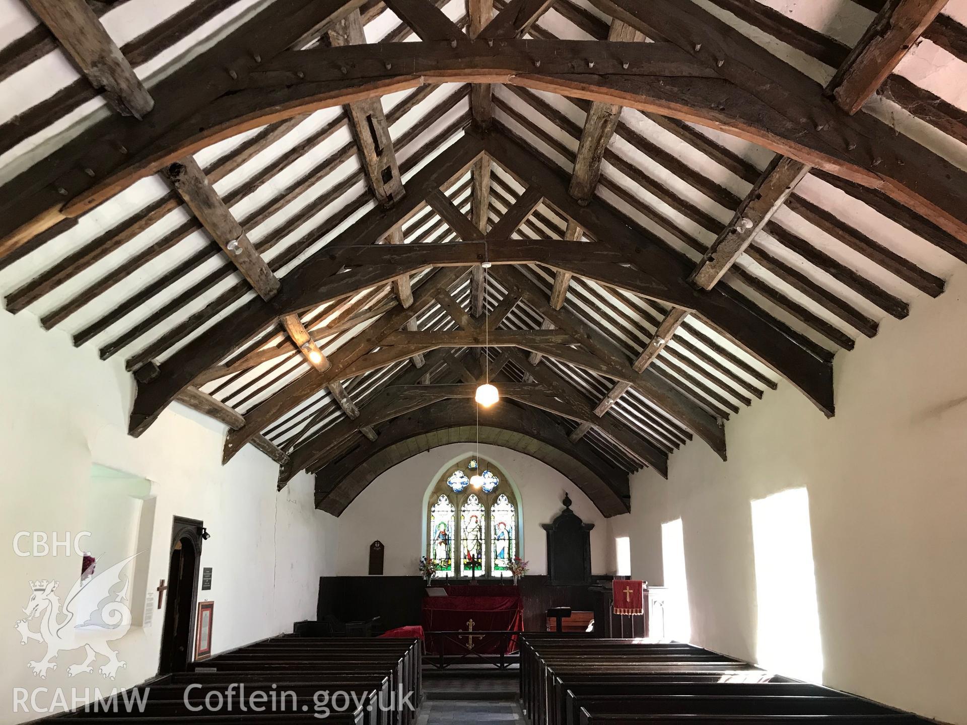 Colour photograph showing interior view of Eglwys Mihangel (St. Michael's Church) looking beyond the pews to the altar, Llanfihangel-y-Pennant, taken by Paul R. Davis on 28th March 2019.