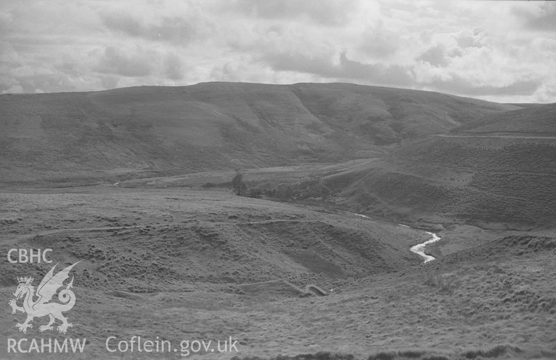 Digital copy of black & white negative showing landscape view looking south down the Tywi to Moel Prysgau farmstead from the new forestry road, south east of Pontrhydfendigaid. Photographed by Arthur O. Chater in August 1965 from Grid Reference SN 809 614.